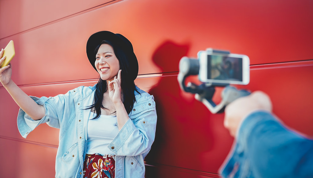 Asian fashion girl vlogging and using mobile smartphone outdoor by Alessandro Biascioli on 500px