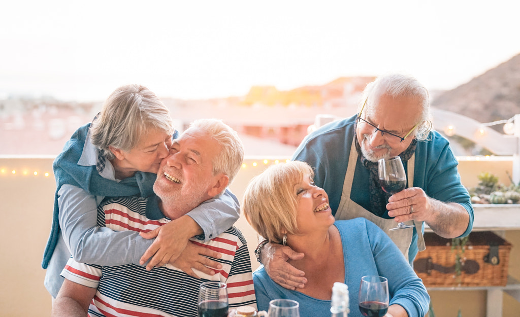 Happy seniors couple having fun dining together on terrace by Alessandro Biascioli on 500px.com