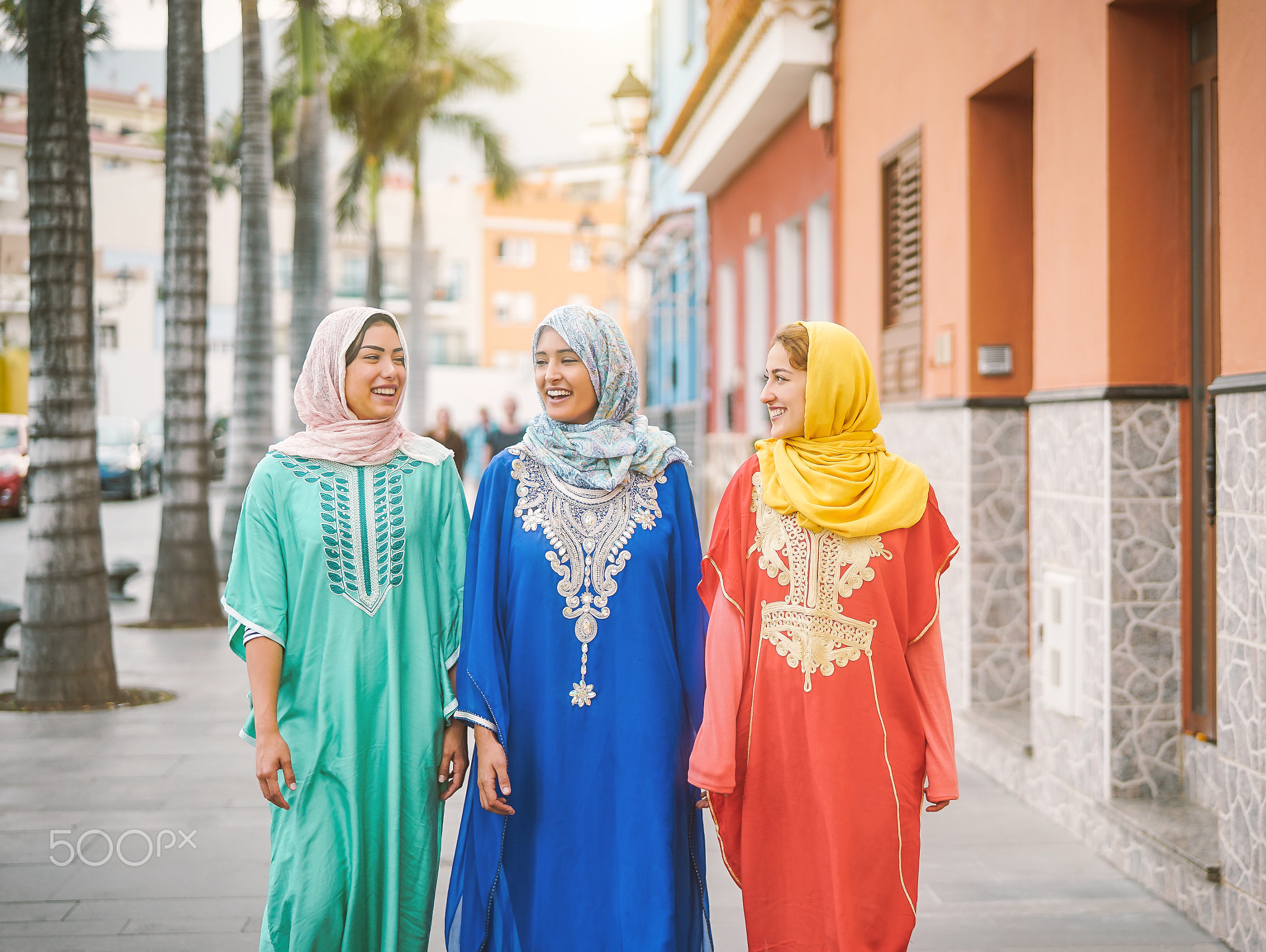 Happy muslim women walking in the city center