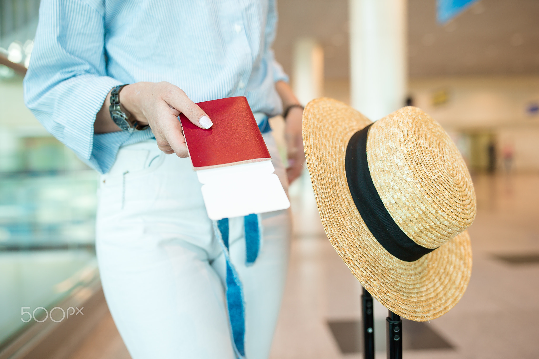 Close-up of passports and boarding pass in female hands at airport