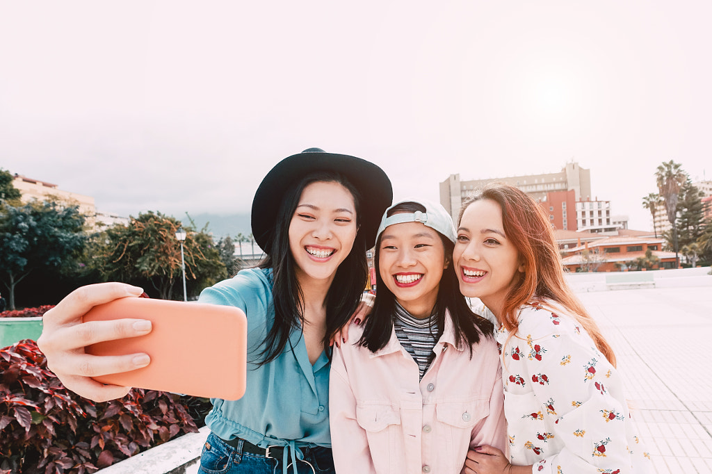 Happy Asian girls taking selfie with mobile smartphone outdoor by Alessandro Biascioli on 500px.com