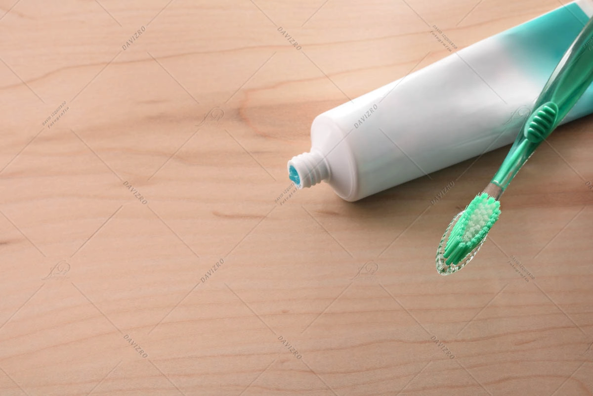 Toothbrush and toothpaste on wood table dental hygiene concept