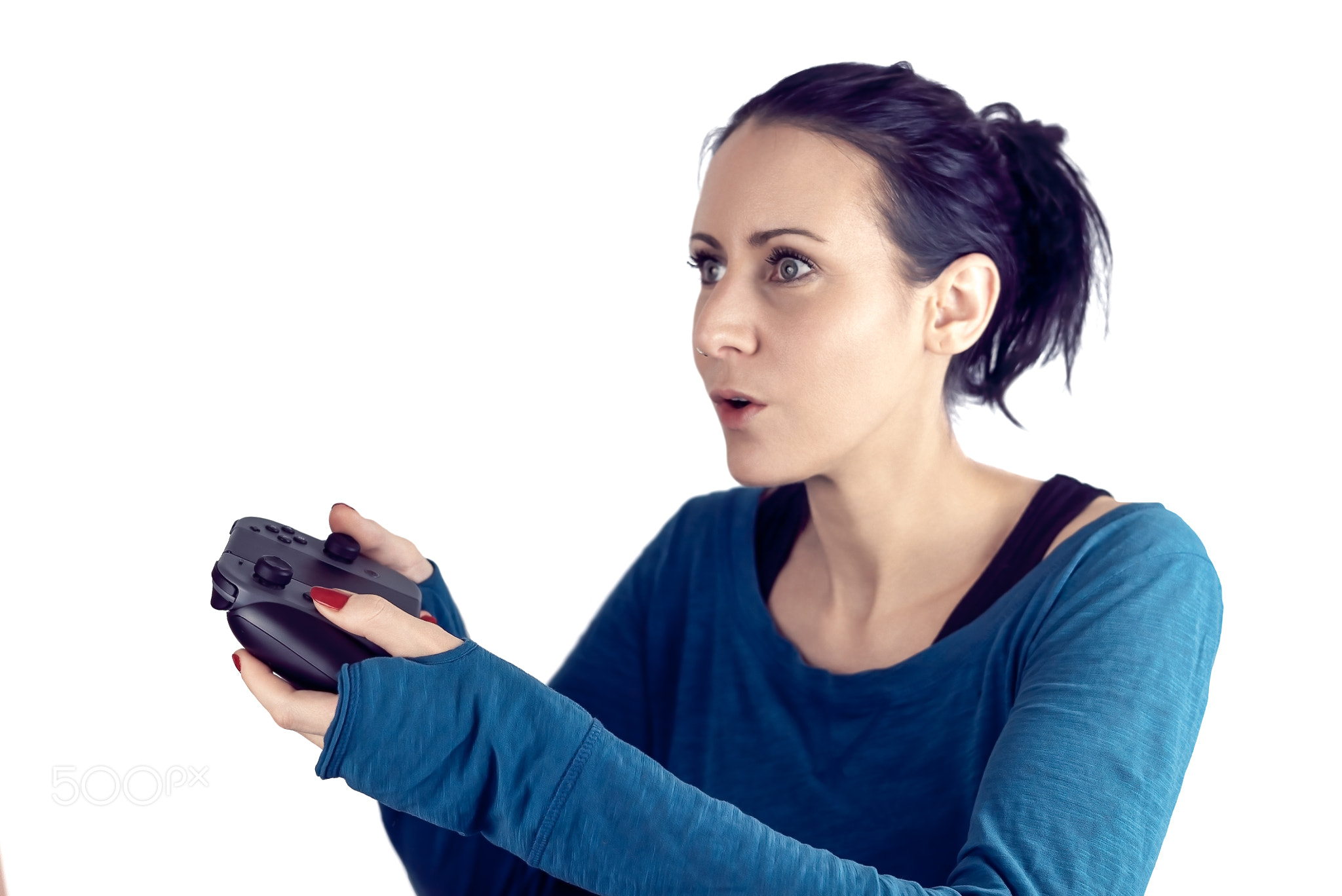 Young woman with blue sweater and red nail polish playing video game on wireless gaming...