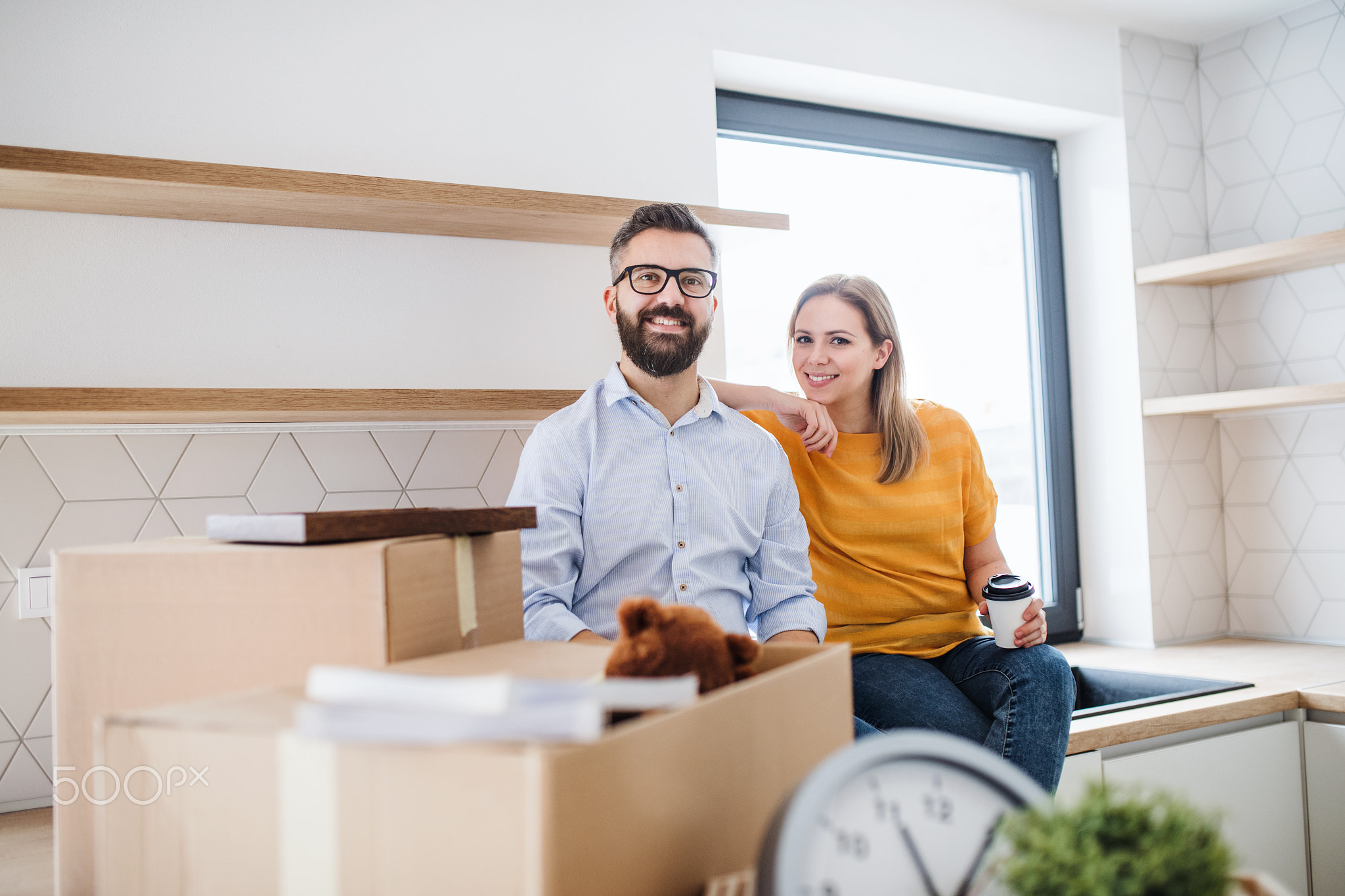 A young couple moving in new home.