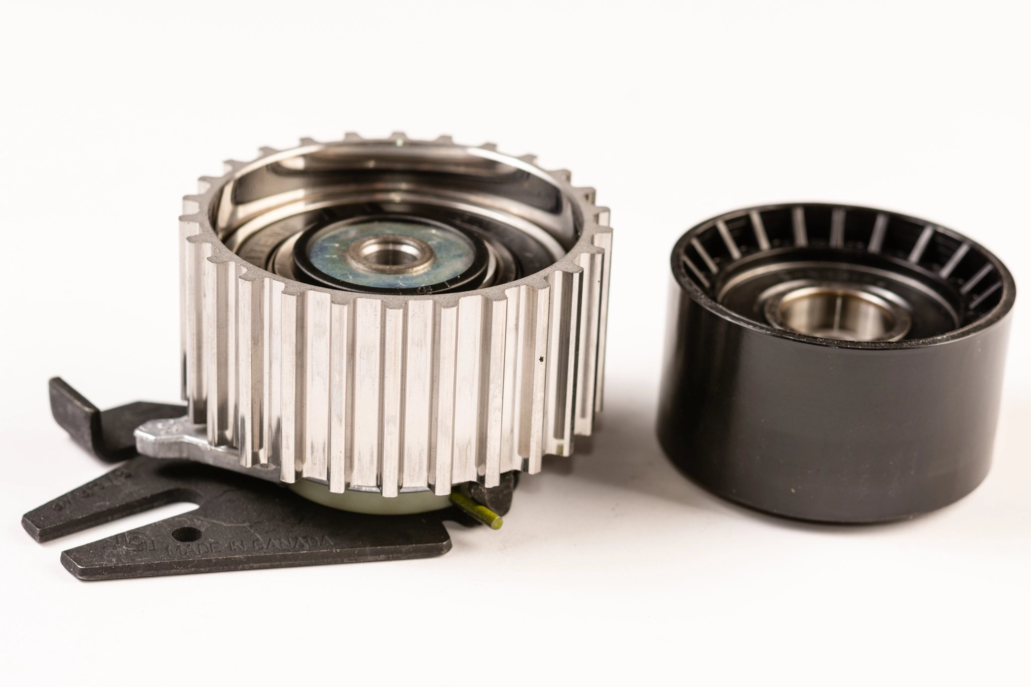Timing belt gear wheel above white background.