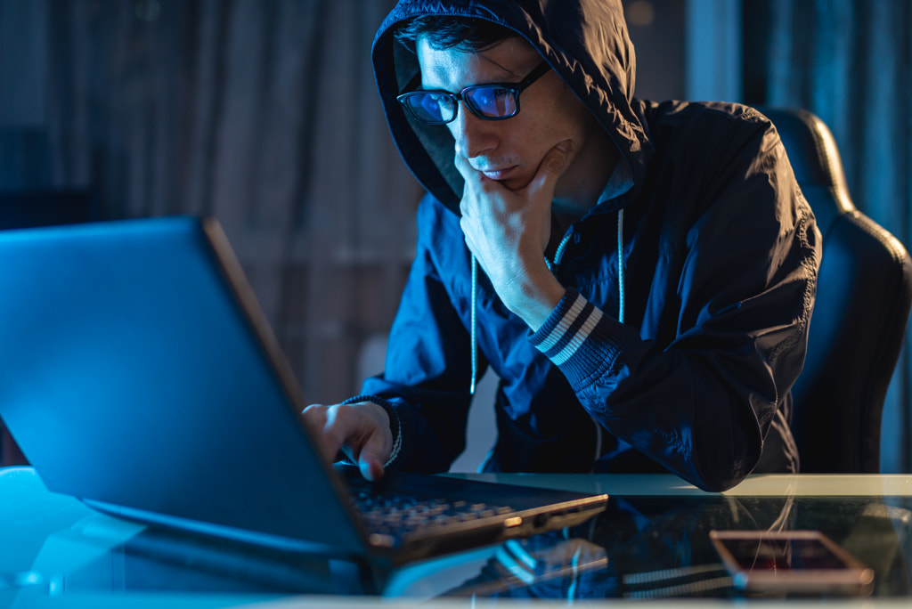 Hacker in the hood typing program code while stealing access databases with passwords. Cyber... by Artem Oleshko on 500px.com