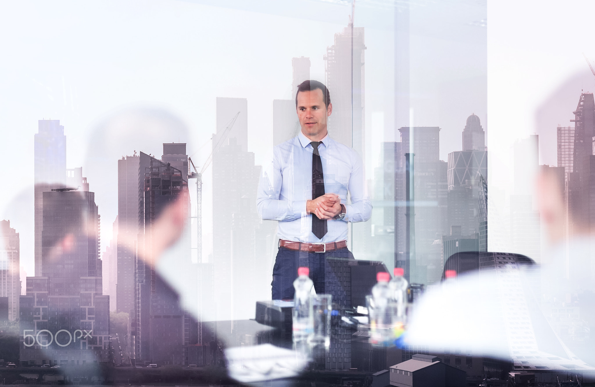 Confident company leader on business meeting against new york city manhattan buildings and...