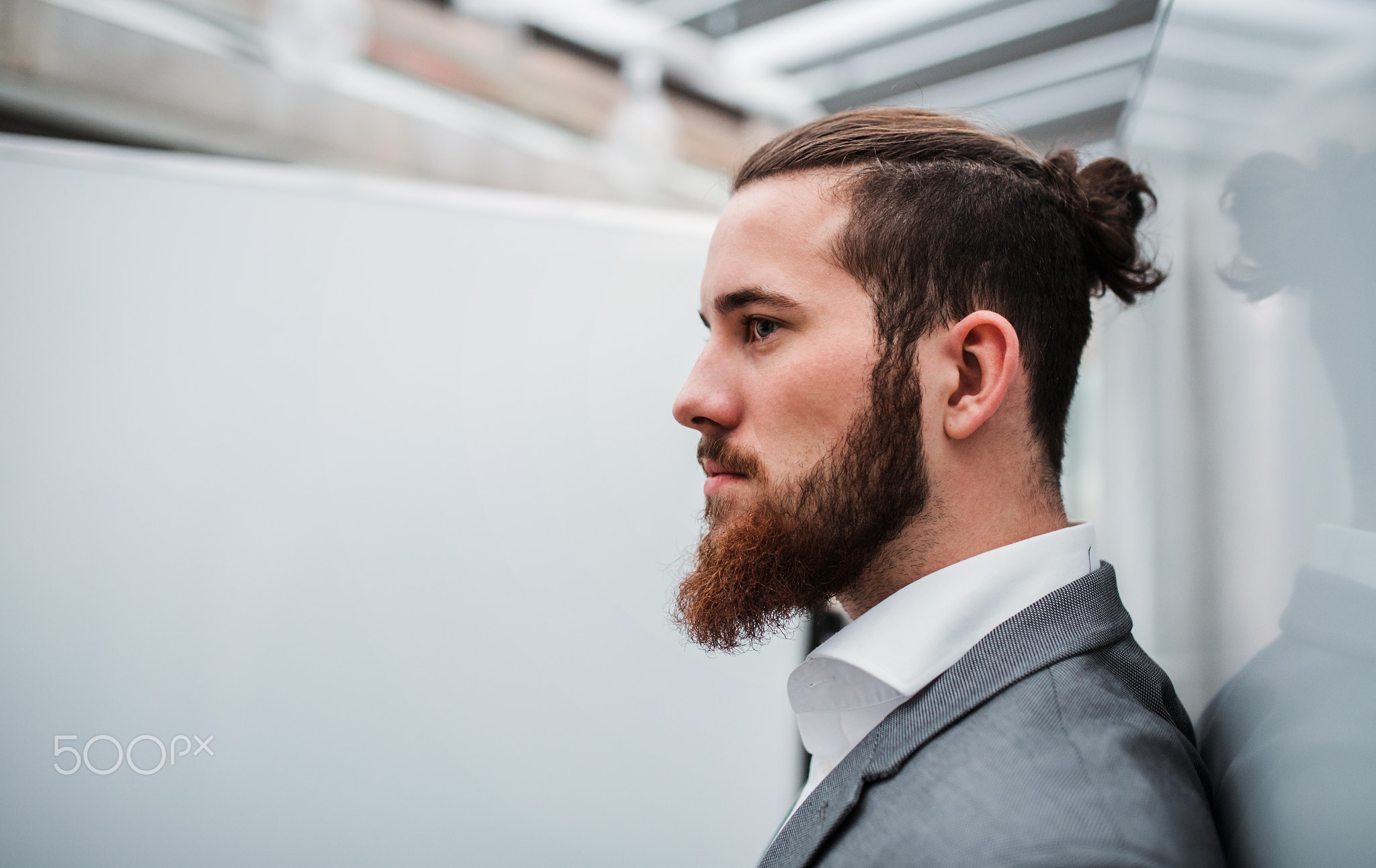 A side view portrait of young businessman in office. Copy space.