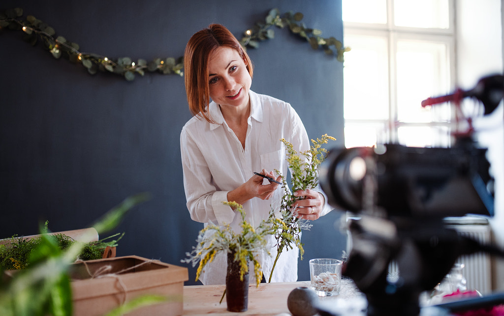 Young creative woman vlogger in a flower shop. A startup of florist business. by Jozef Polc on 500px.com