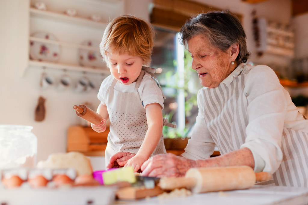 Senior grandmother with small toddler boy making cakes at home. by Jozef Polc on 500px.com