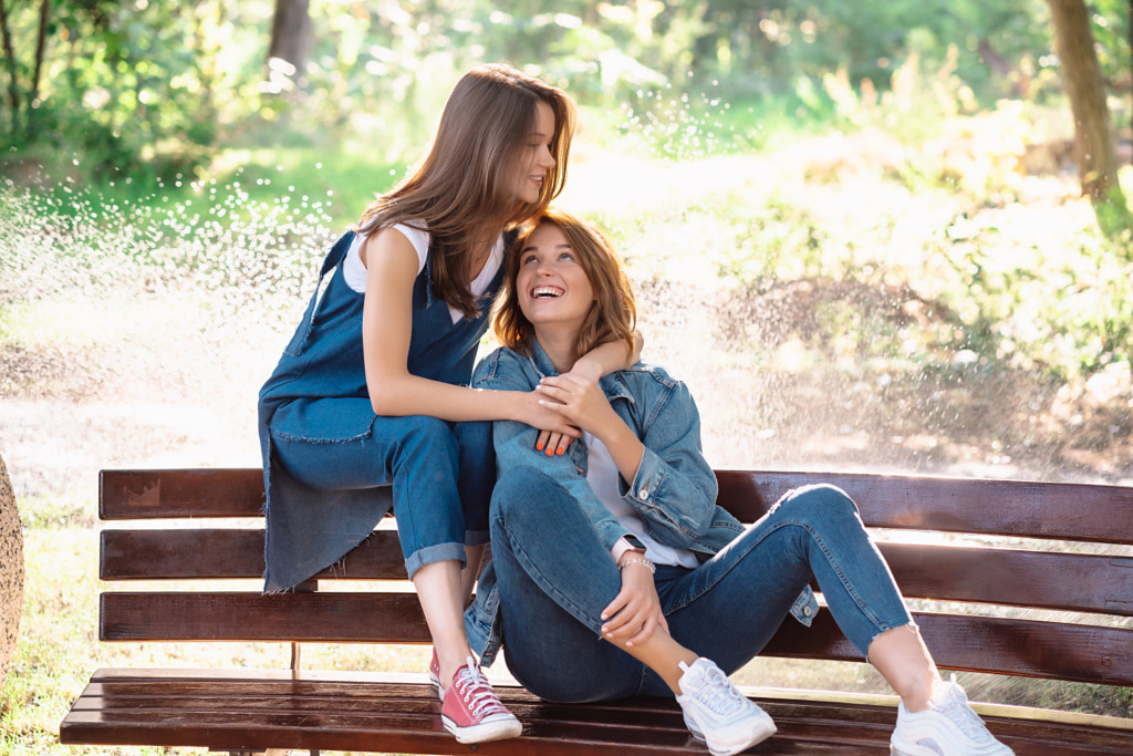 Two beautiful young woman resting on a bench by Oleksii Hrecheniuk on 500px.com