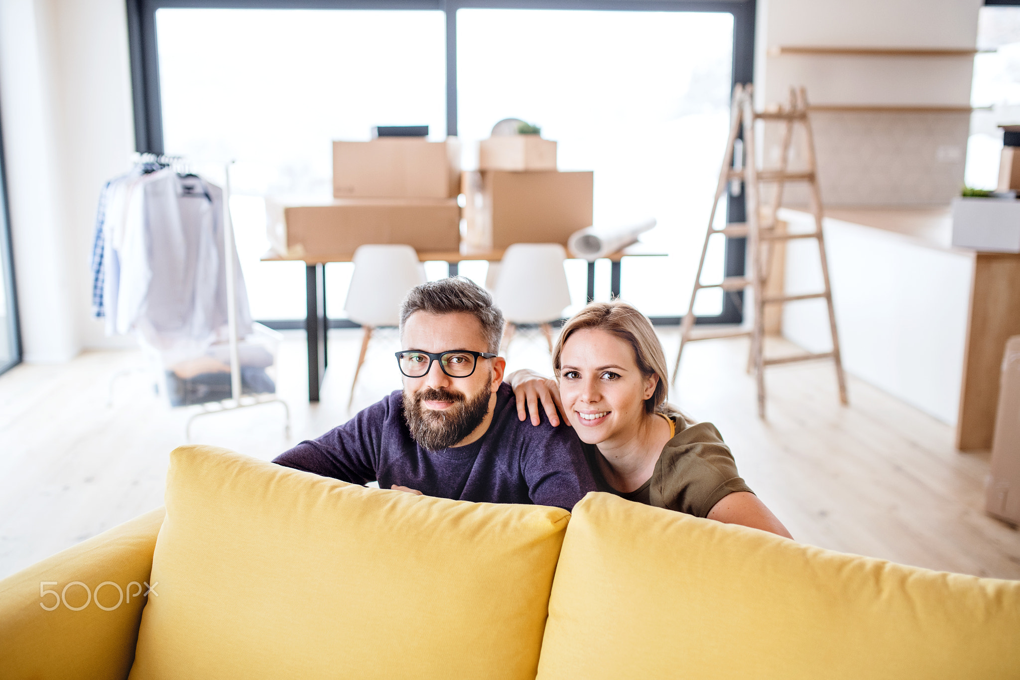 A portrait of young couple moving in new home.