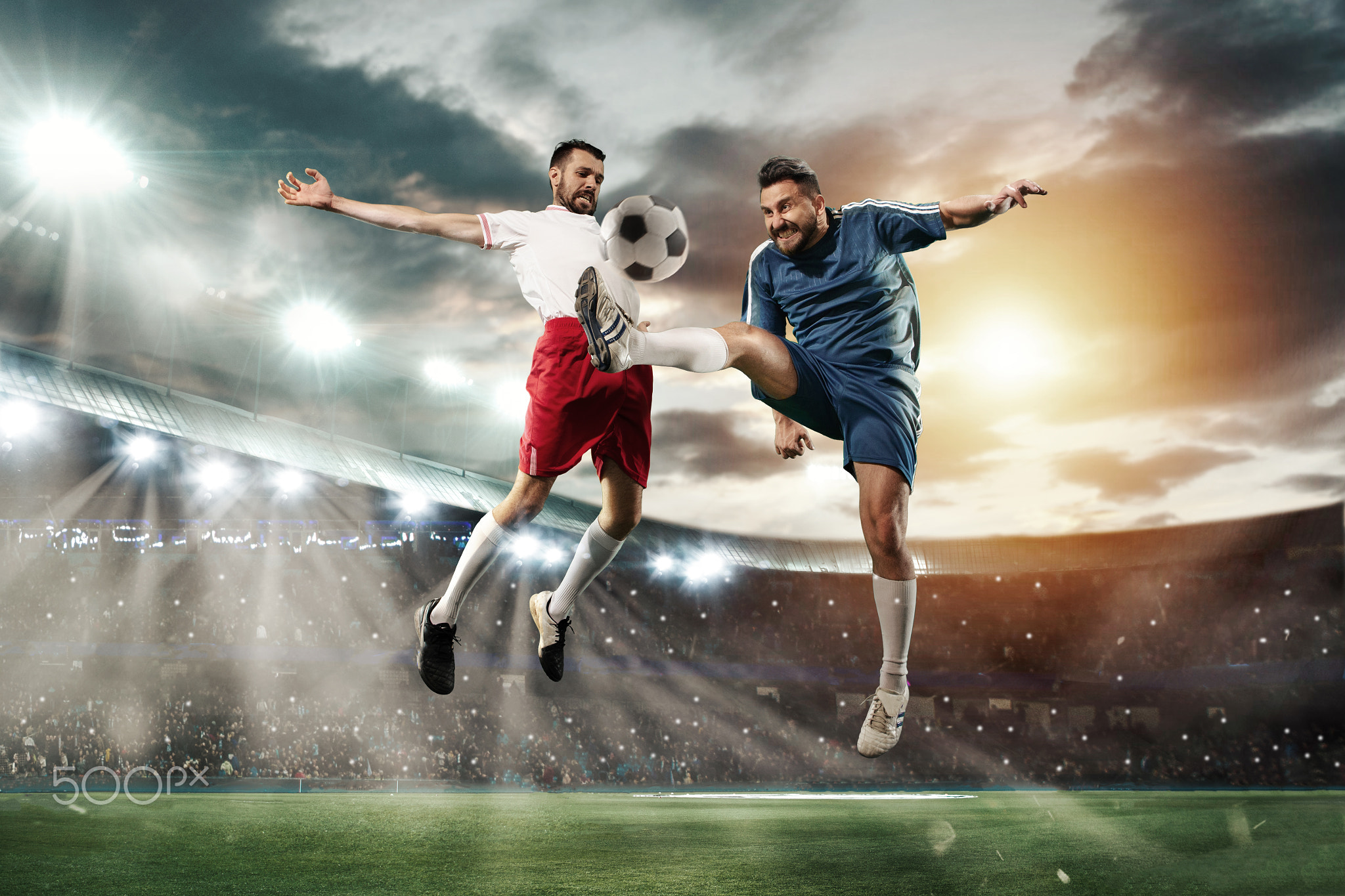 Two men are playing soccer and they compete with each other