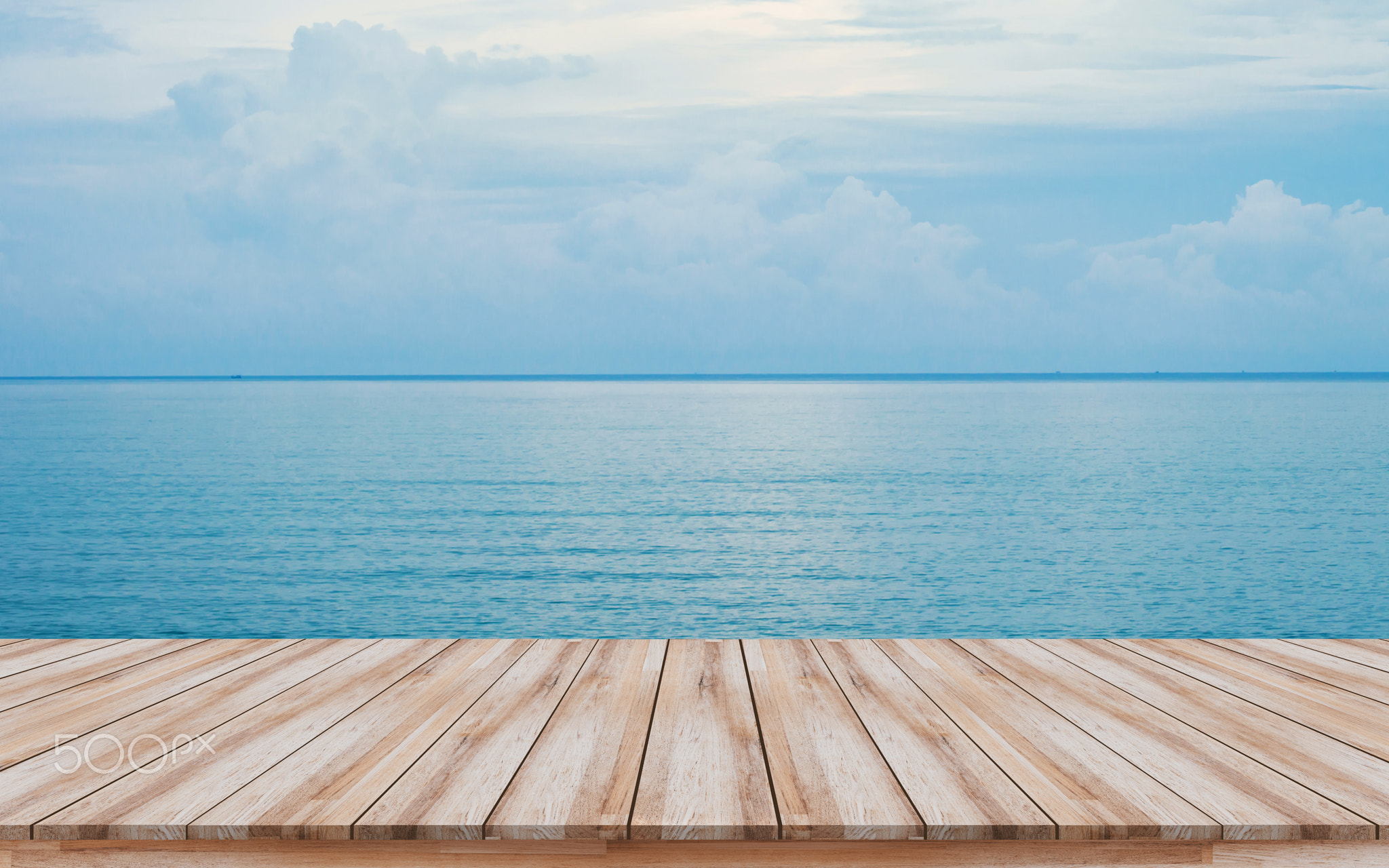 Empty wooden pier with beautiful blue sea background for montage products display
