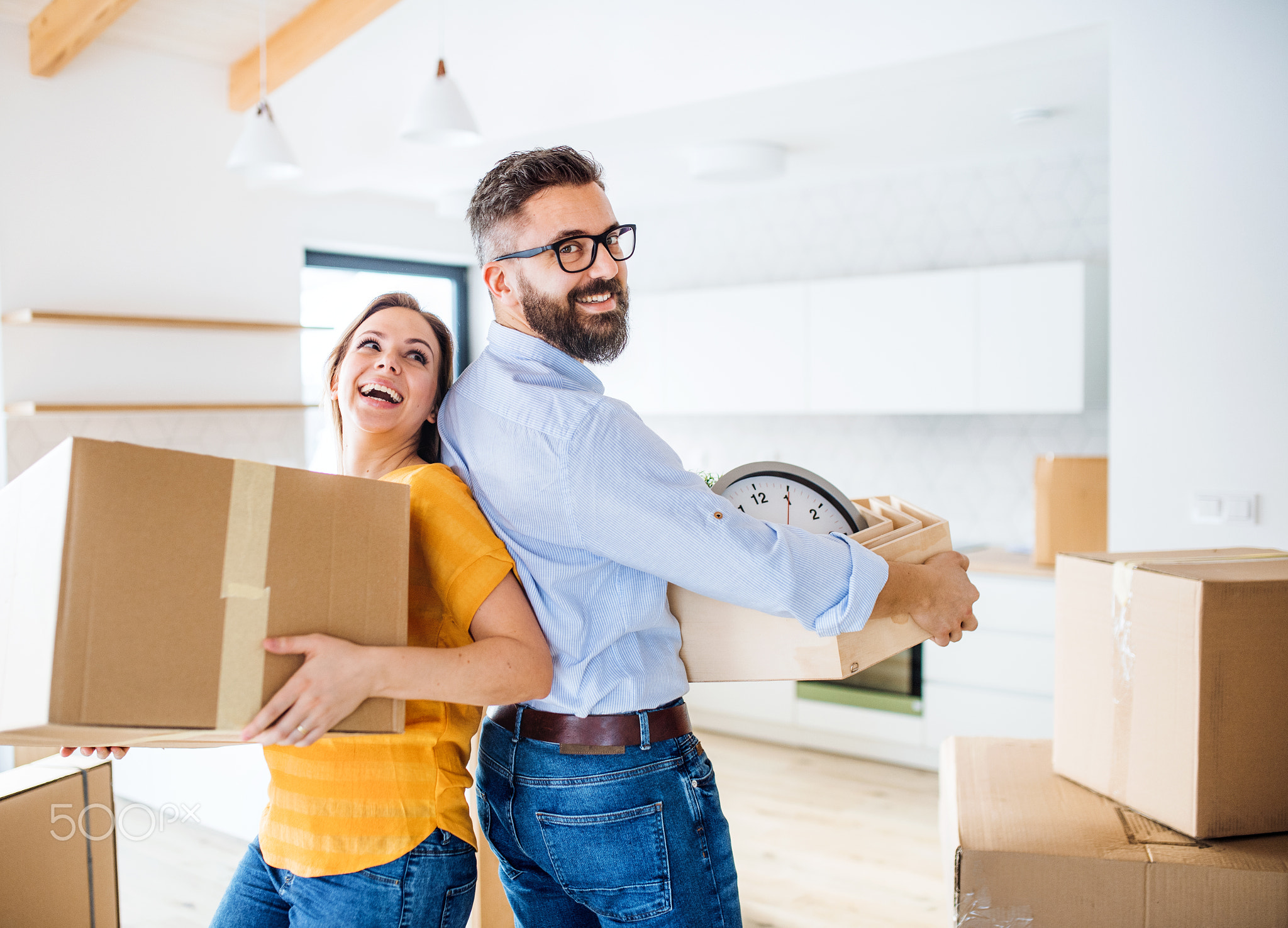 A young couple moving in new home, having fun.