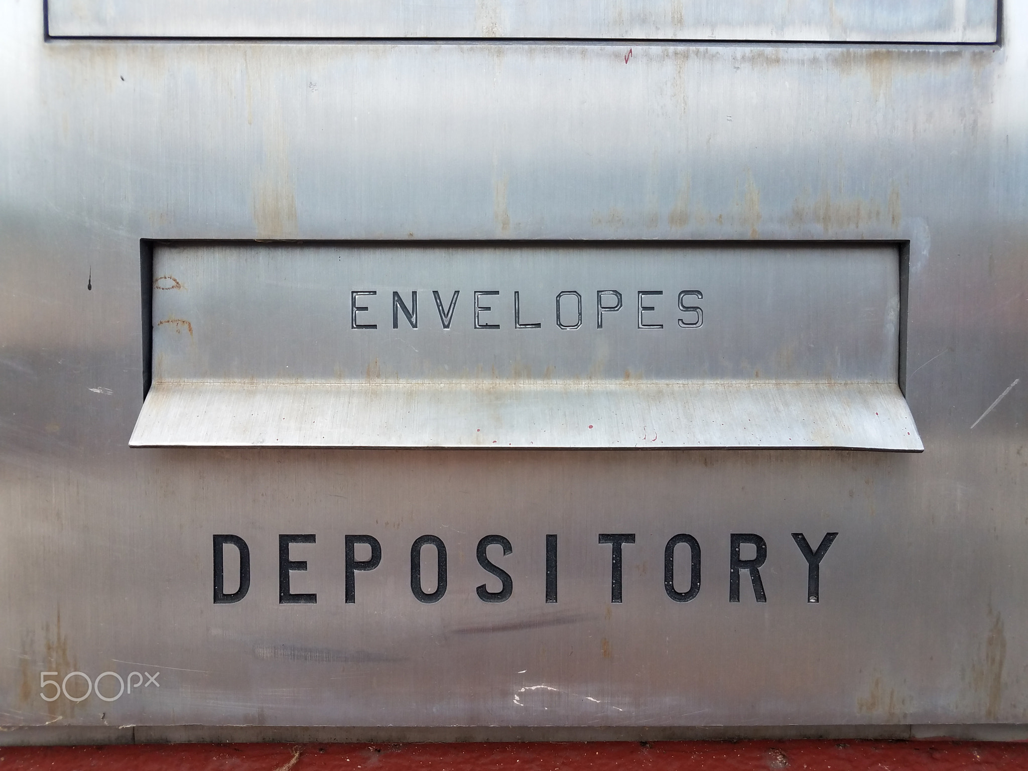 envelopes and depository sign with slot on metal at bank