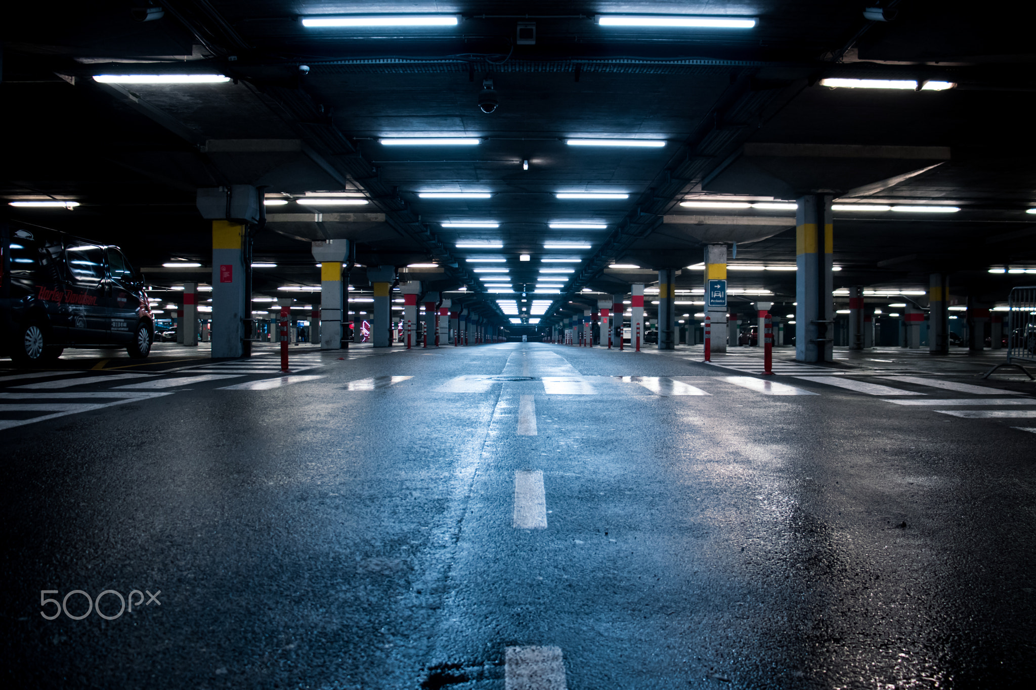 Symmetrical neon lighted reflective shopping mall garage