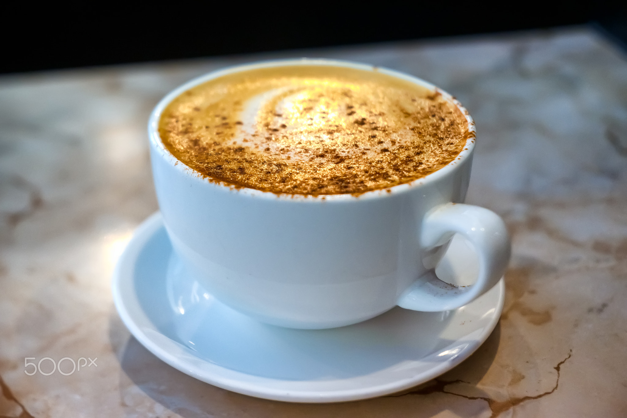 Cup of coffee with cinnamon and honey