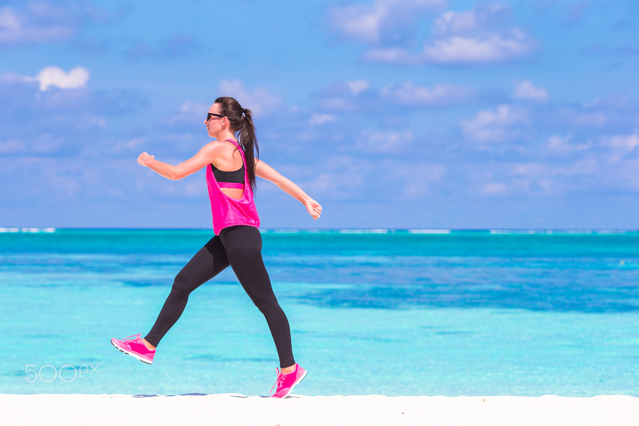 Healthy athlete woman working out doing exercise on tropical white beach