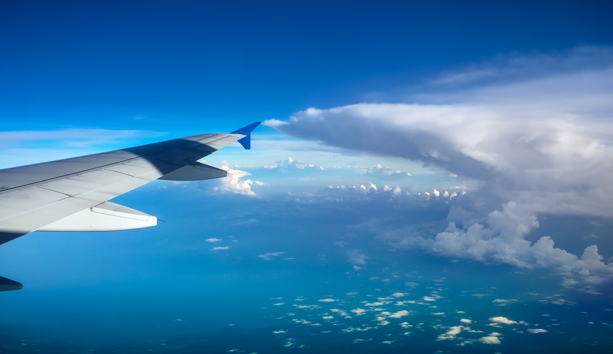 Aircraft wing with Beautiful sky and cloud from the window of a