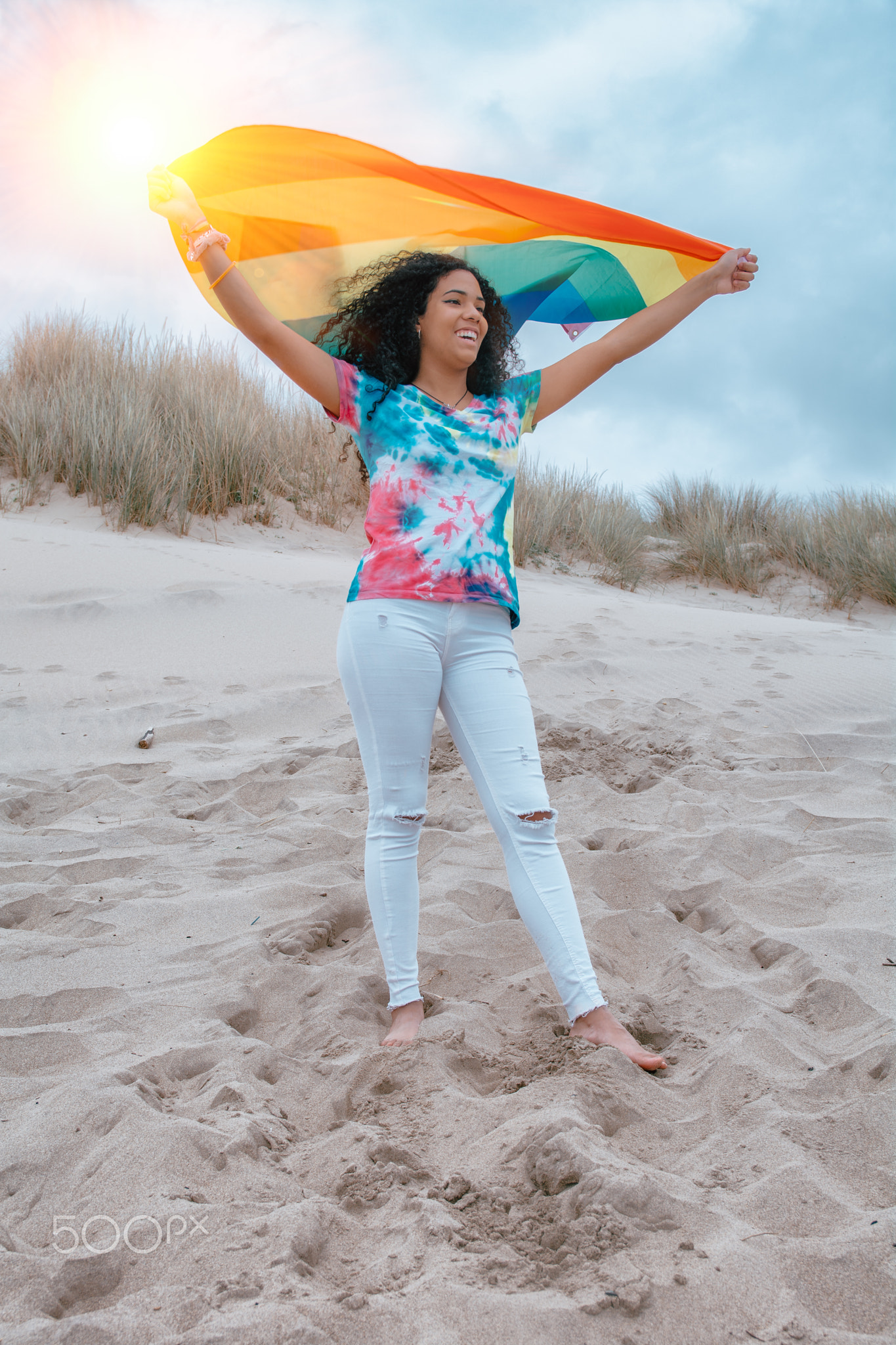 Latina woman Lesbian on the beach holding rainbow Flag Pride - Image