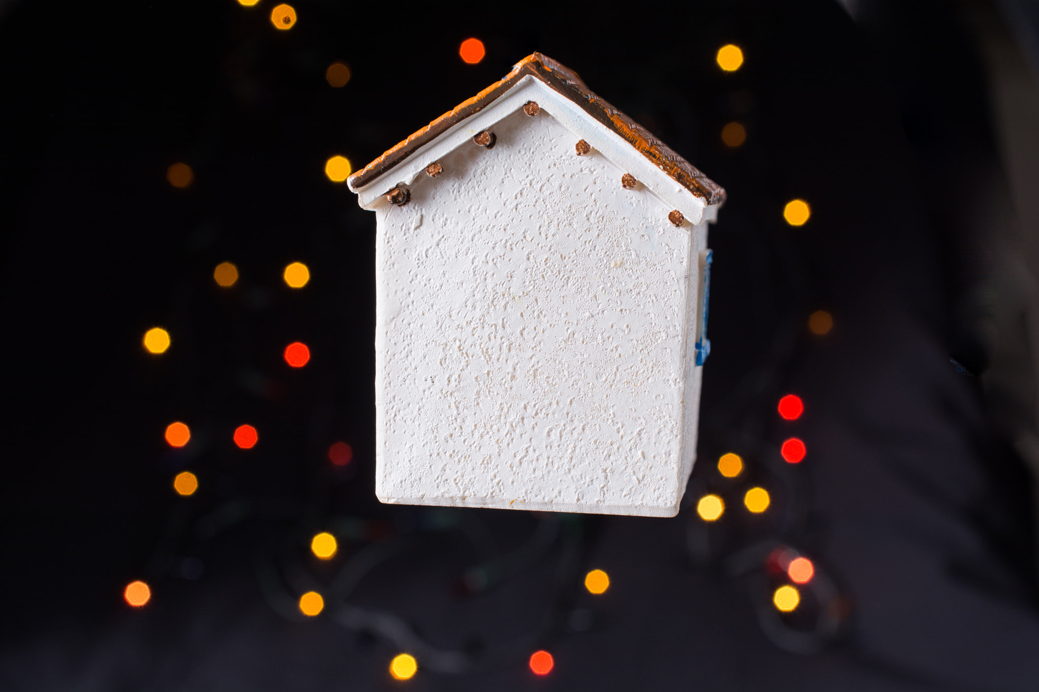Little model house on a bokeh light background