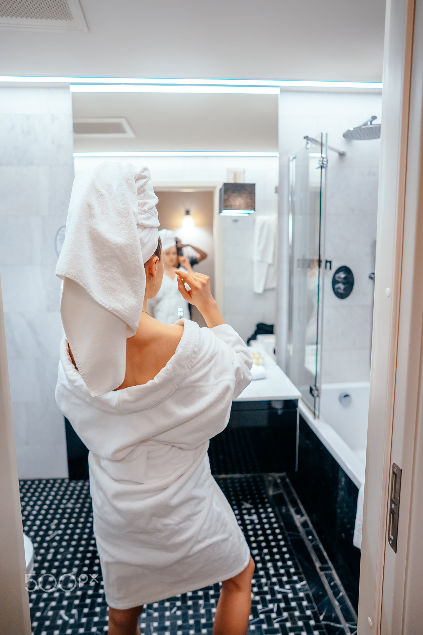 beauty portrait of pretty woman dressing a white bath towel