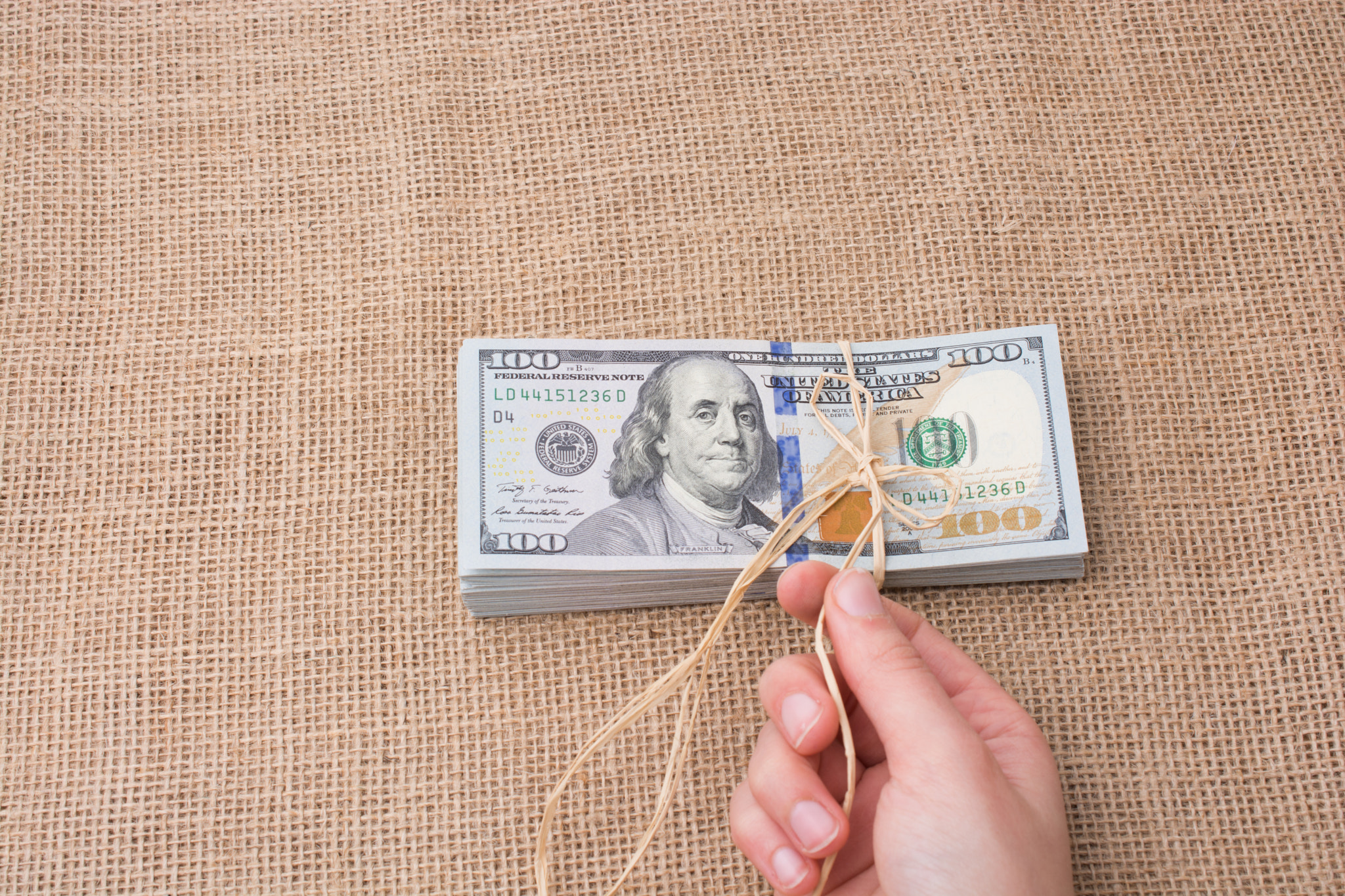 Banknote bundle of US dollar tied with a linen ribbon