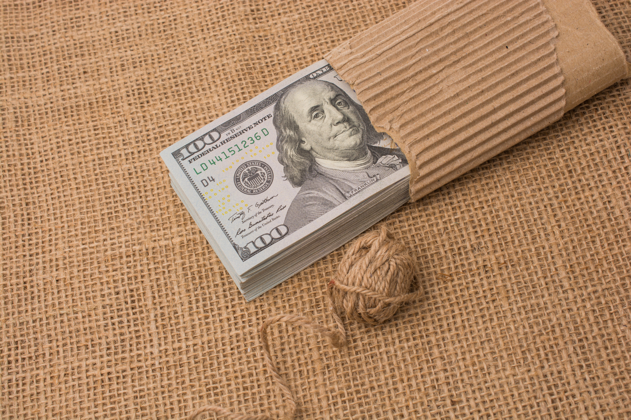 Spool of linen spool is placed on US dollar Banknotes