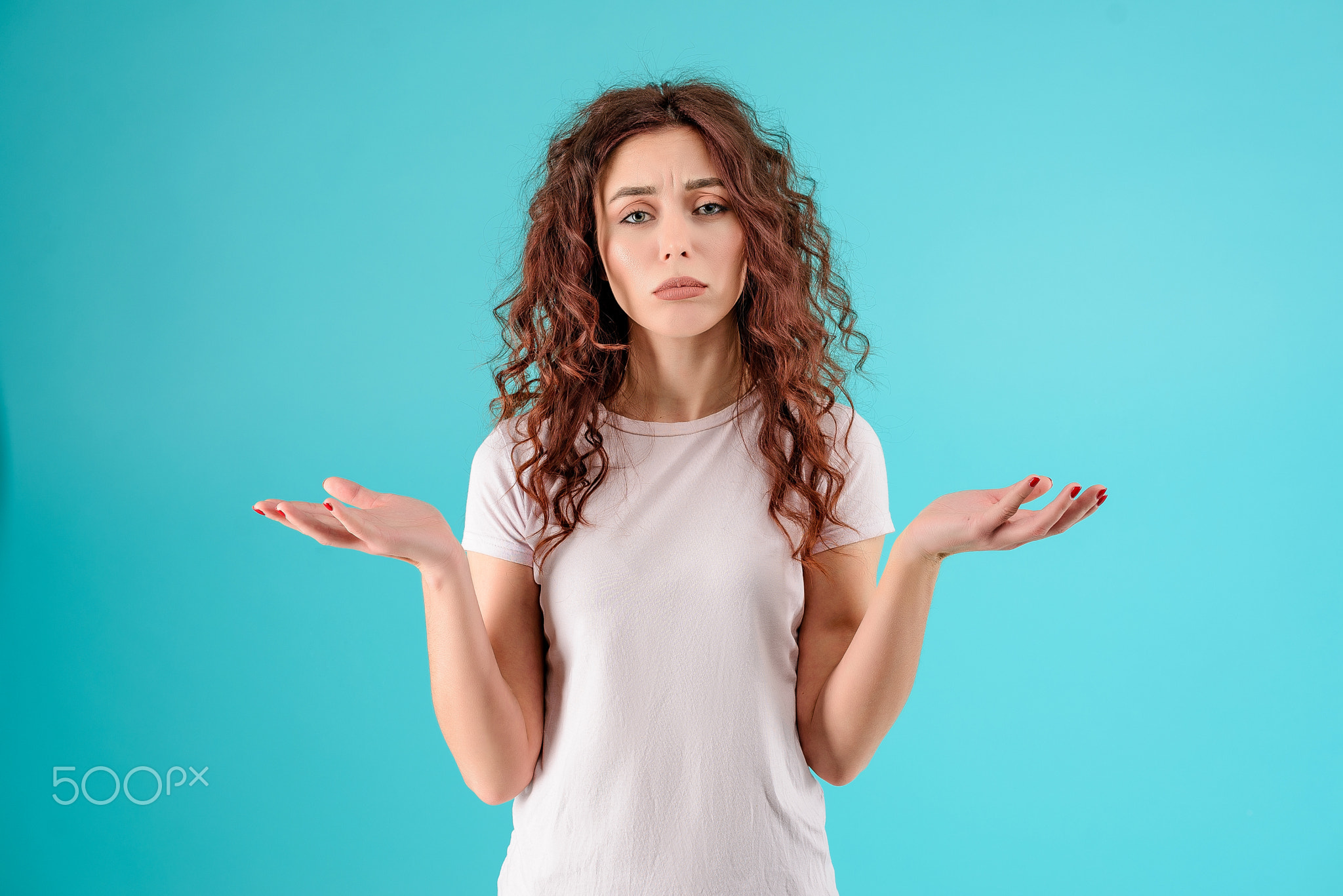 Young woman with curly hair isolated over bright colorful background