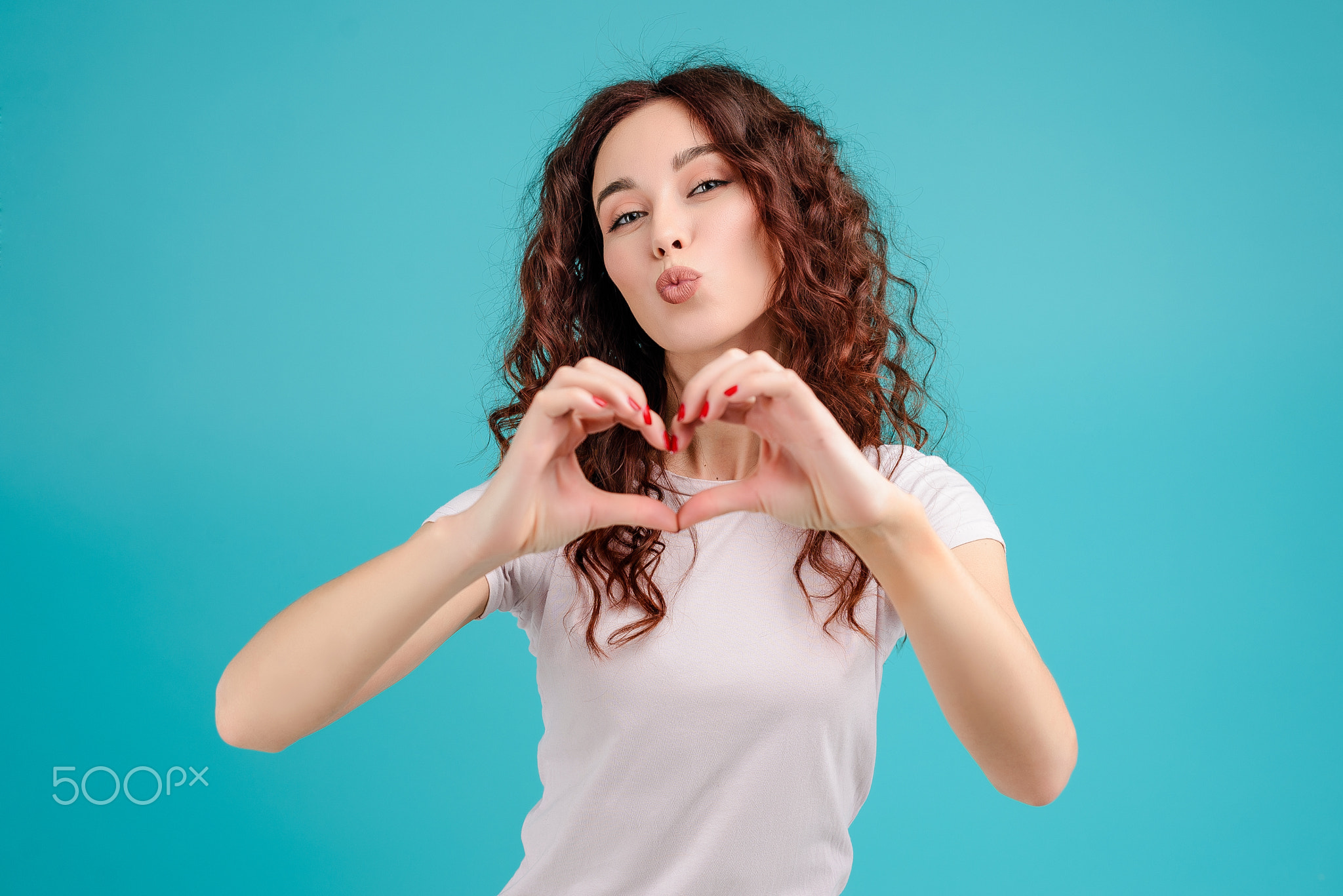 Young woman with curly hair isolated over bright colorful background