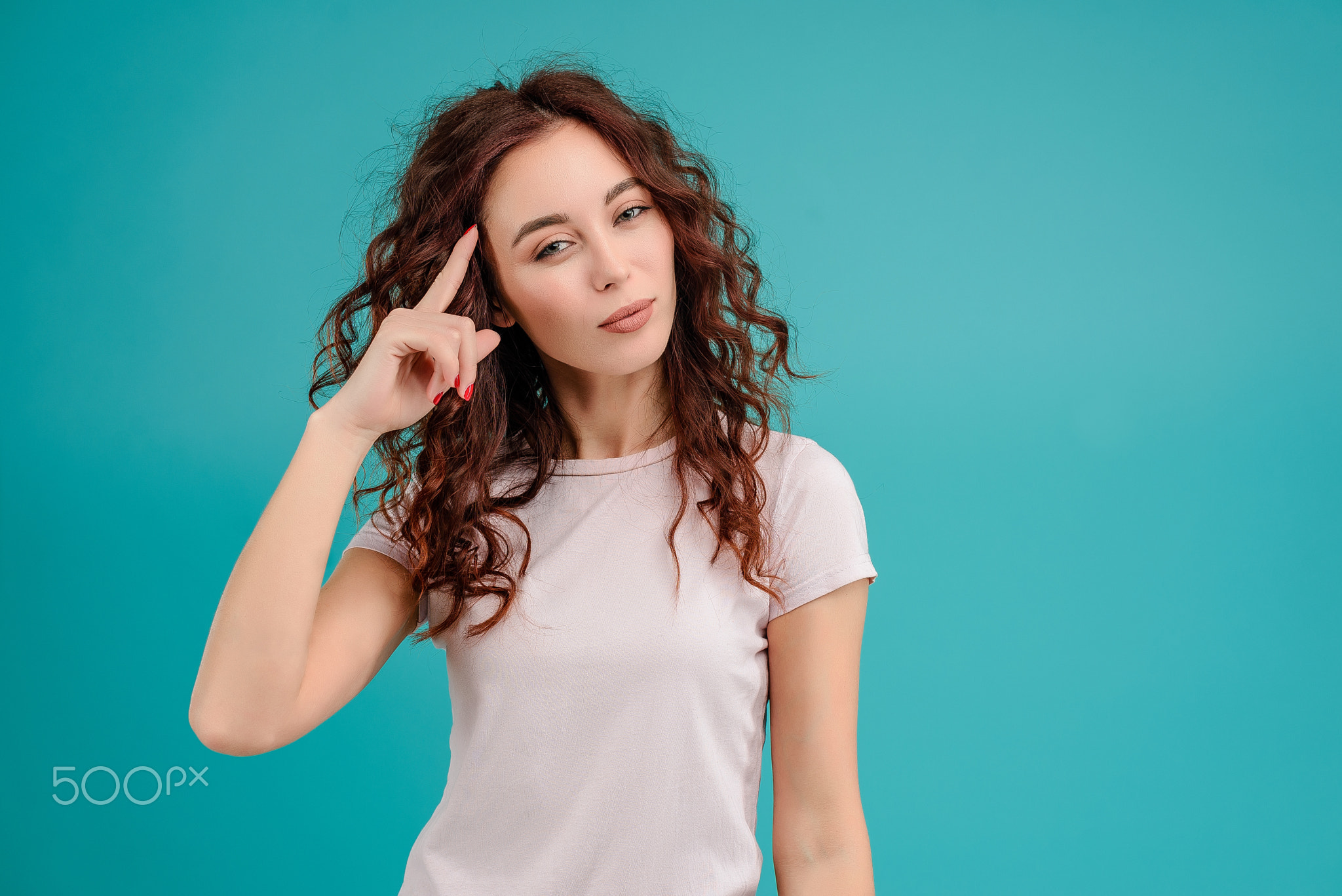 Young woman with curly hair isolated over bright colorful background