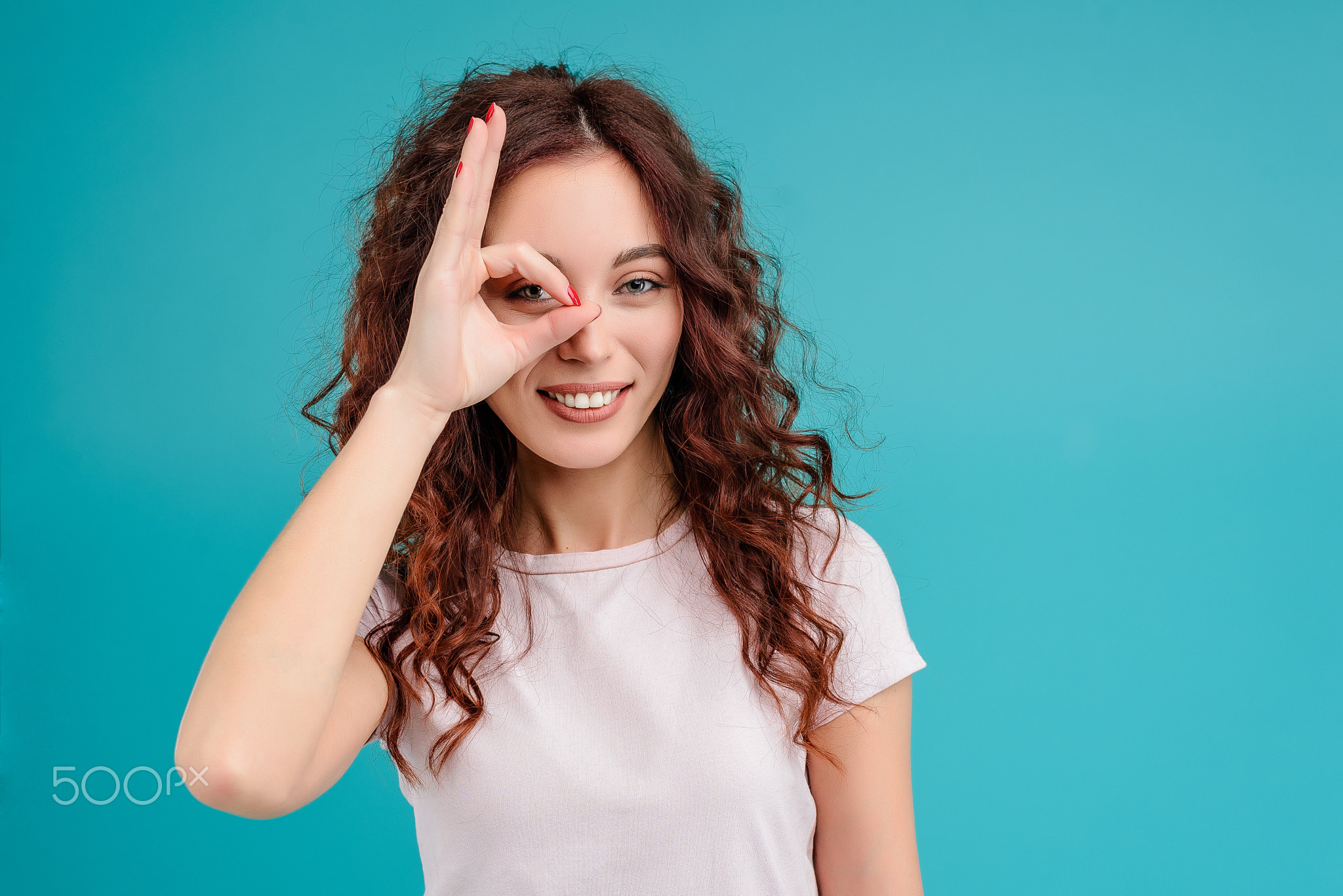 Young woman with curly hair isolated over bright colorful background