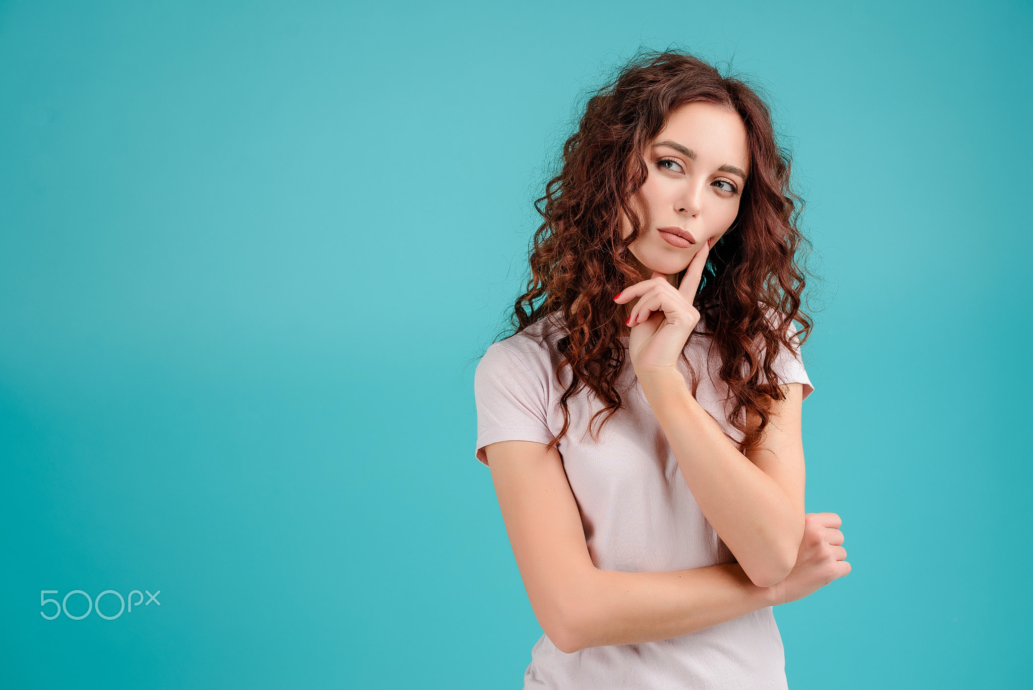 Young woman with curly hair isolated over bright colorful background