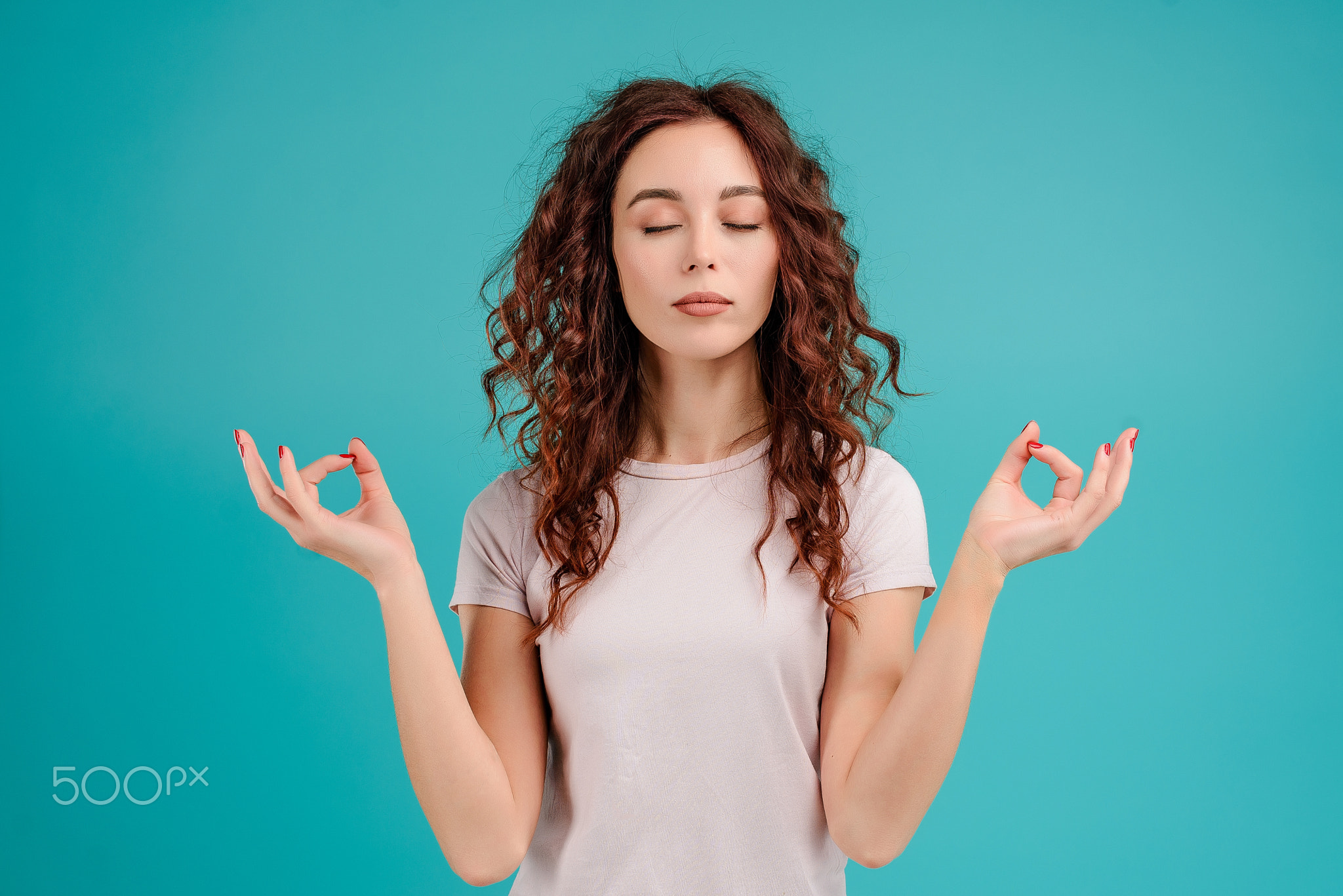 Young woman with curly hair isolated over bright colorful background