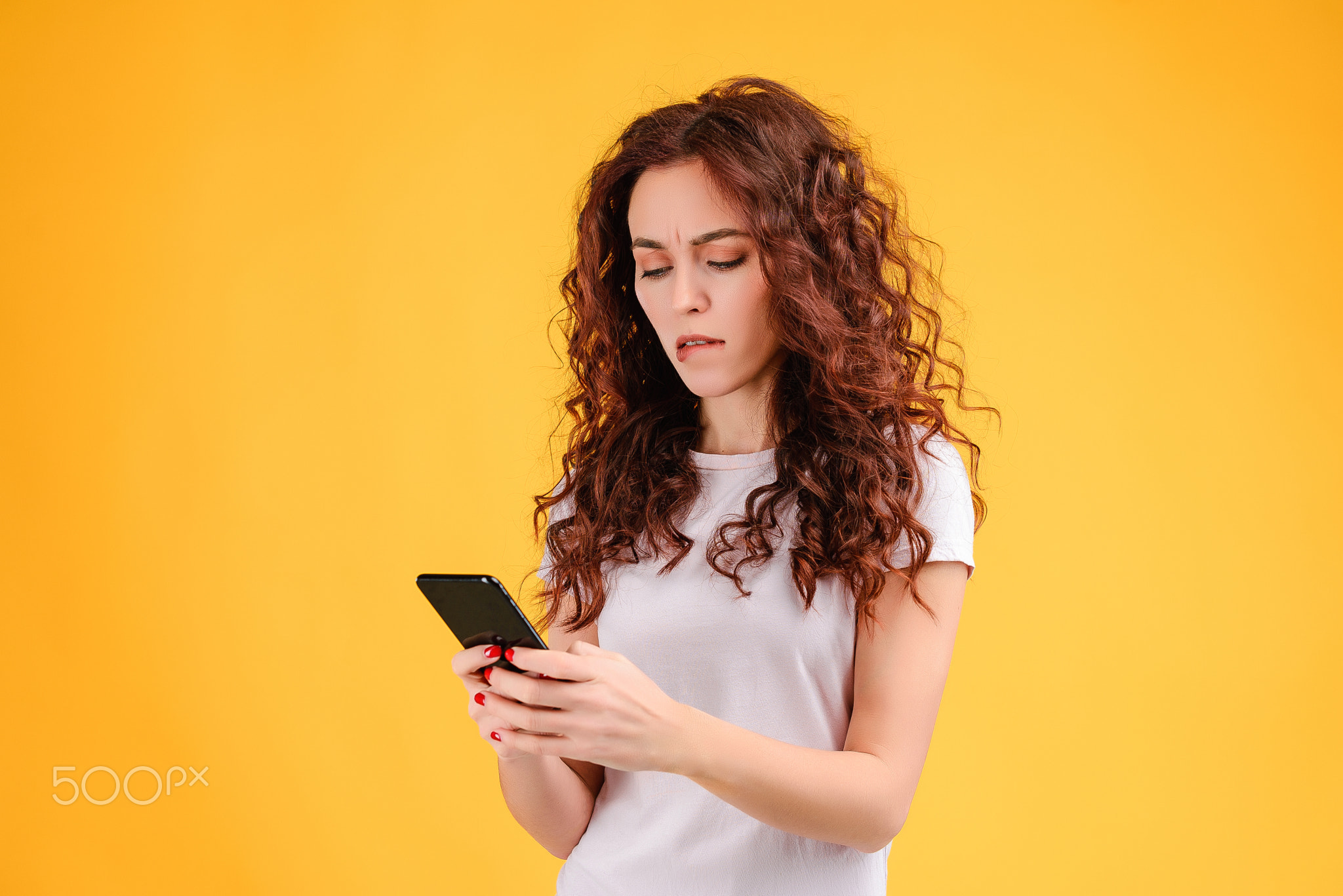 Young woman with curly hair isolated over bright colorful background