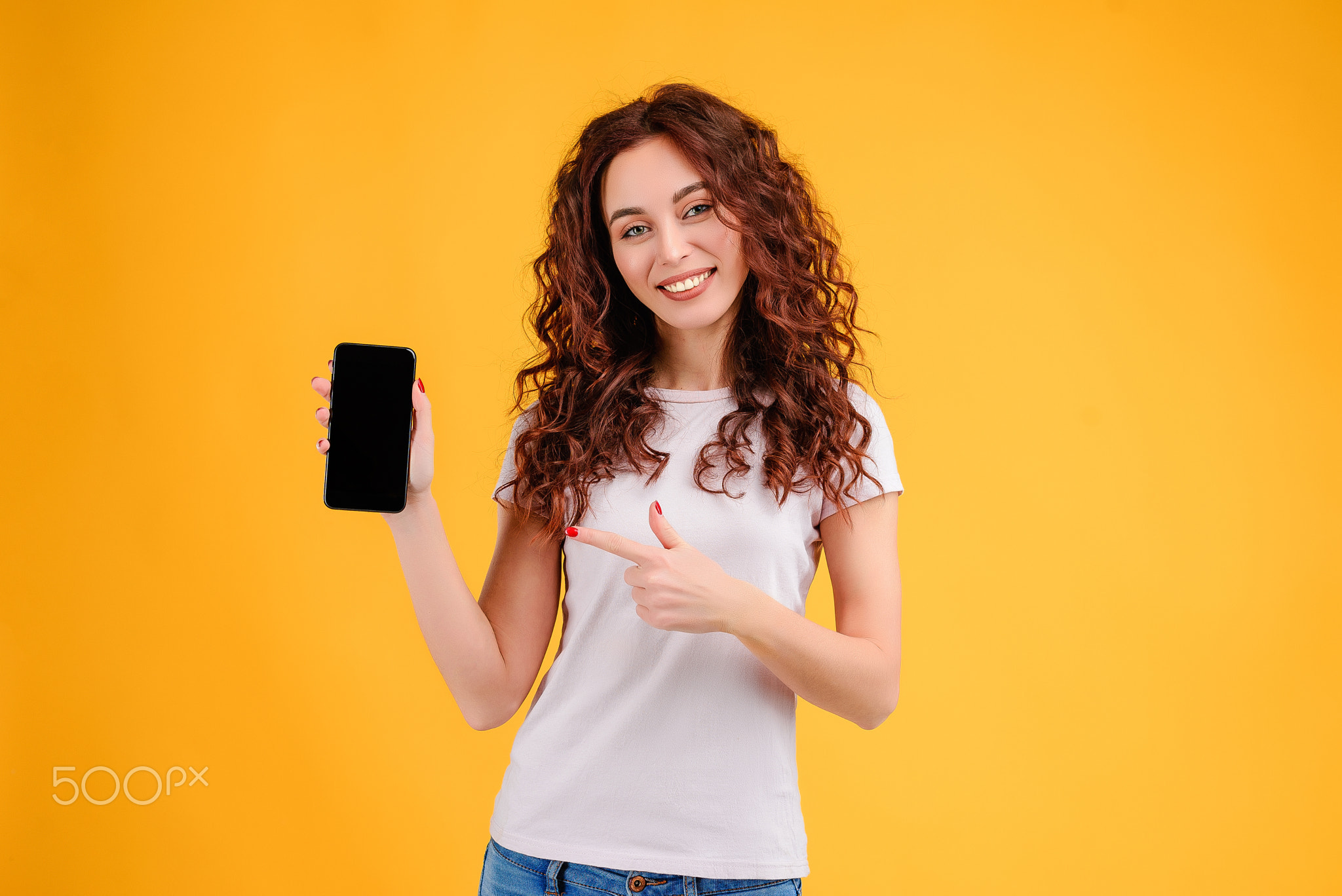 Young woman with curly hair isolated over bright colorful background