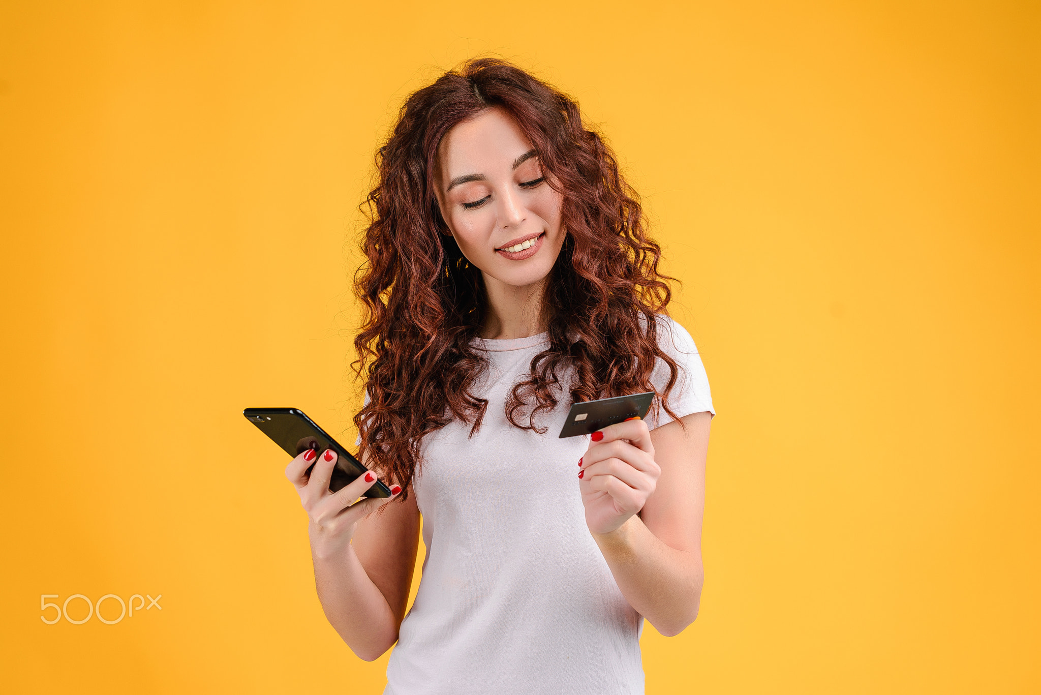 Young woman with curly hair isolated over bright colorful background