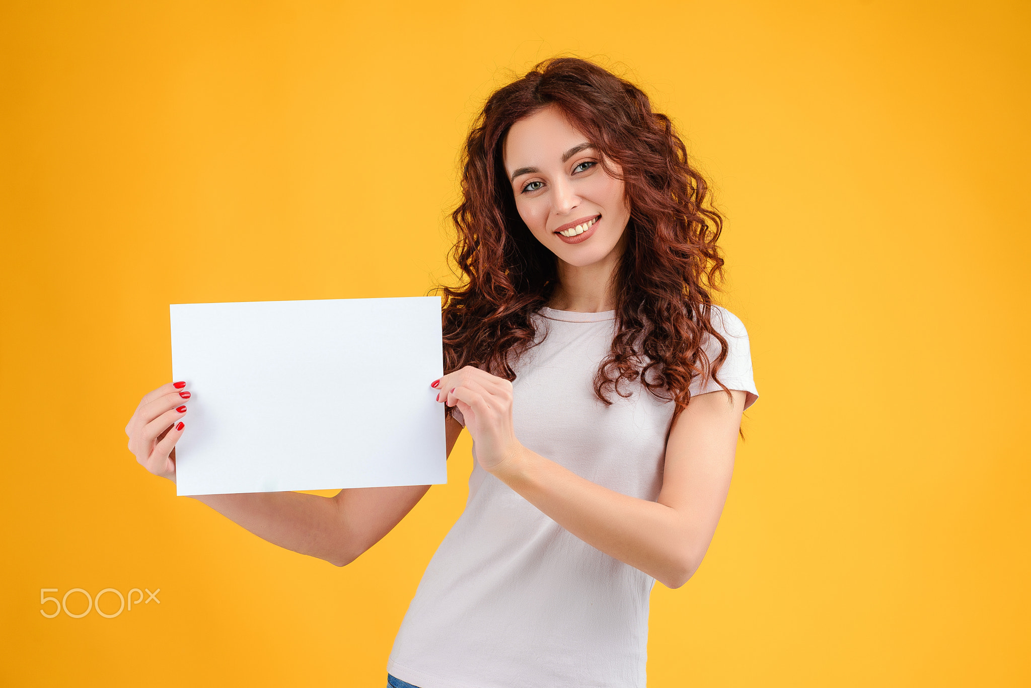 Young woman with curly hair isolated over bright colorful background