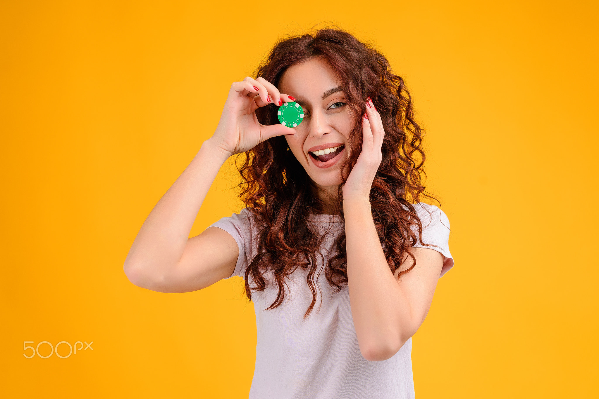 Young woman with curly hair isolated over bright colorful background