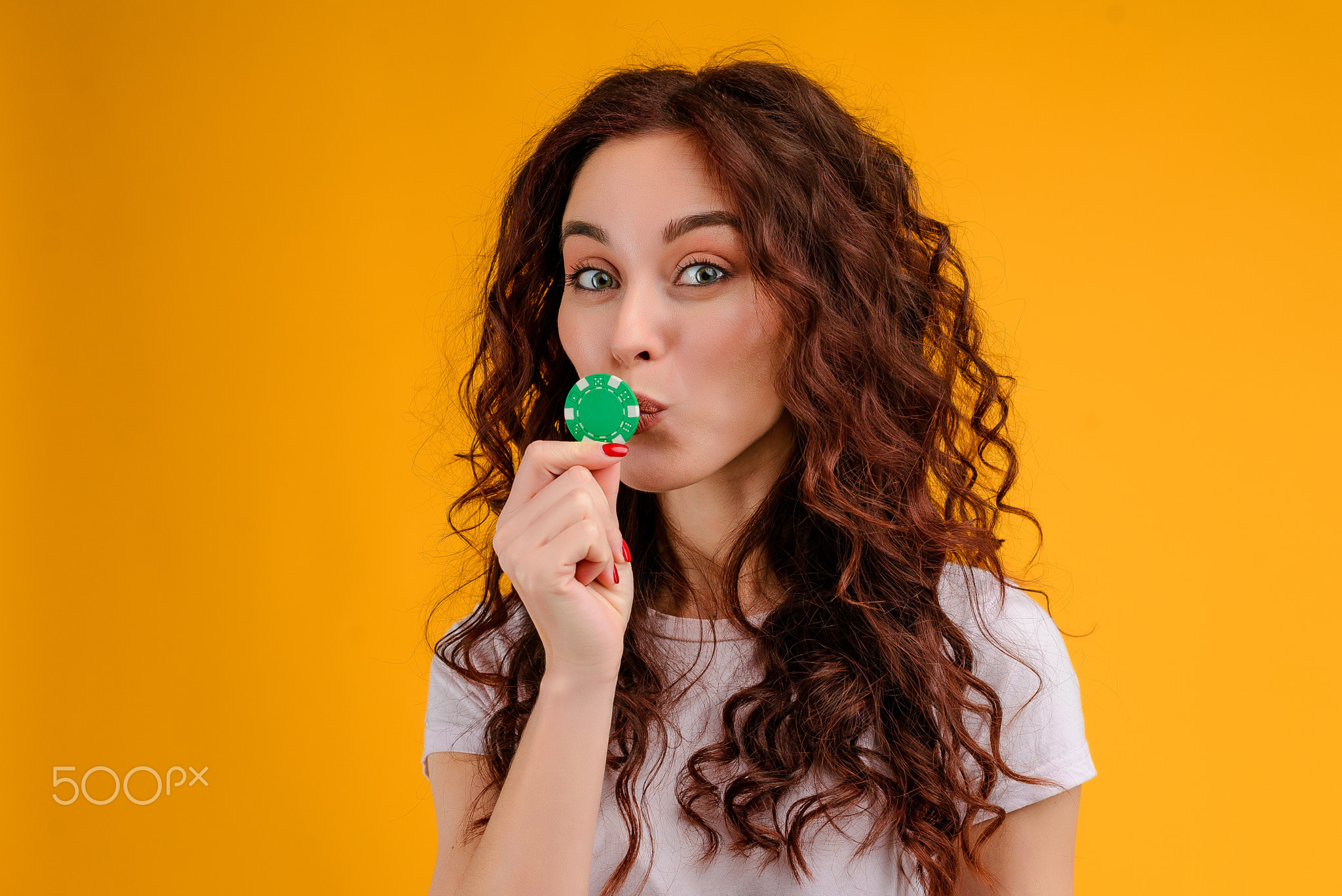 Young woman with curly hair isolated over bright colorful background