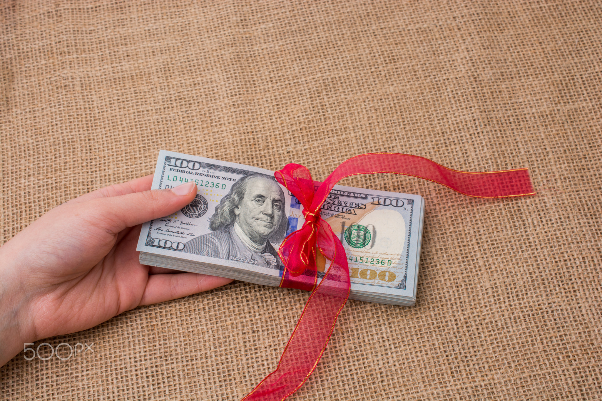 Banknote bundle of US dollar tied with a ribbon