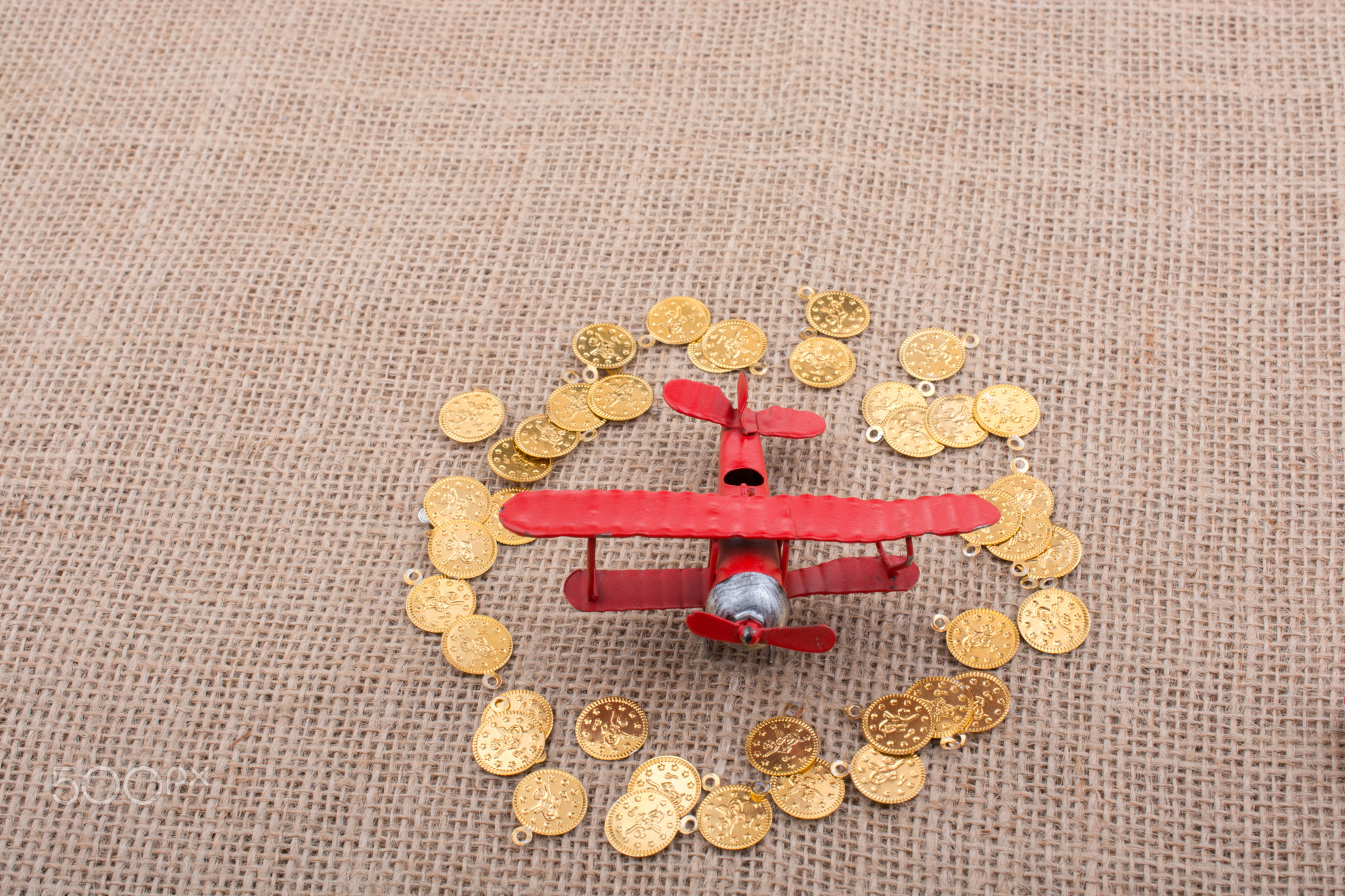Fake gold coins around the retro airplane