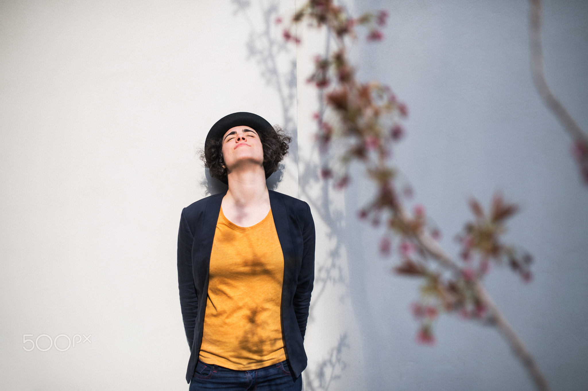 A young businesswoman standing outdoors, relaxing. Copy space.