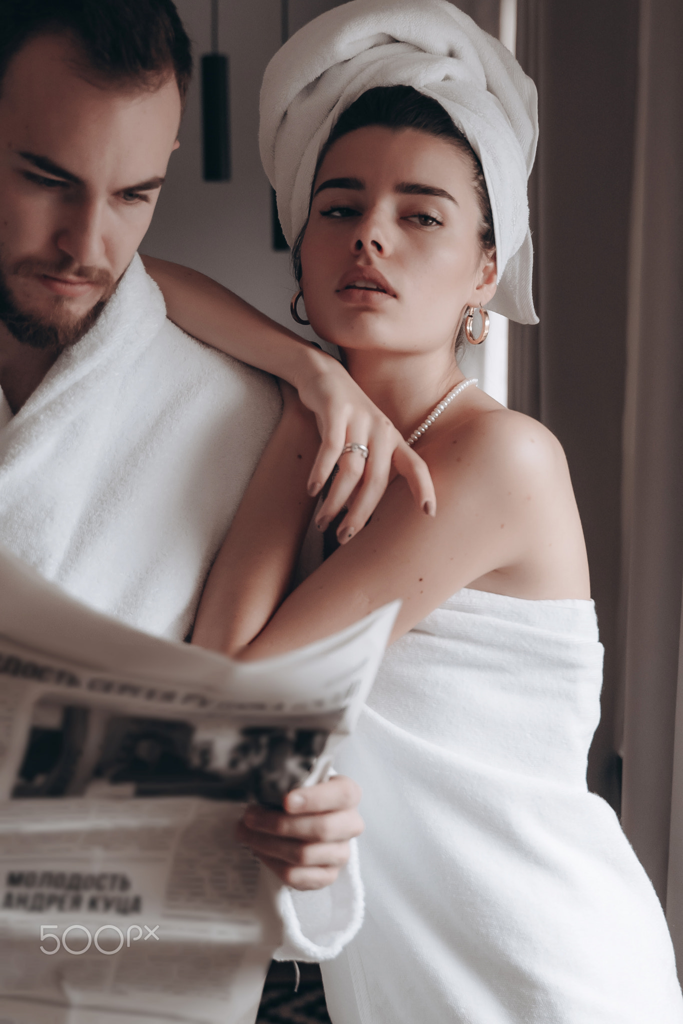 Guy in a white coat and a girl in a towel