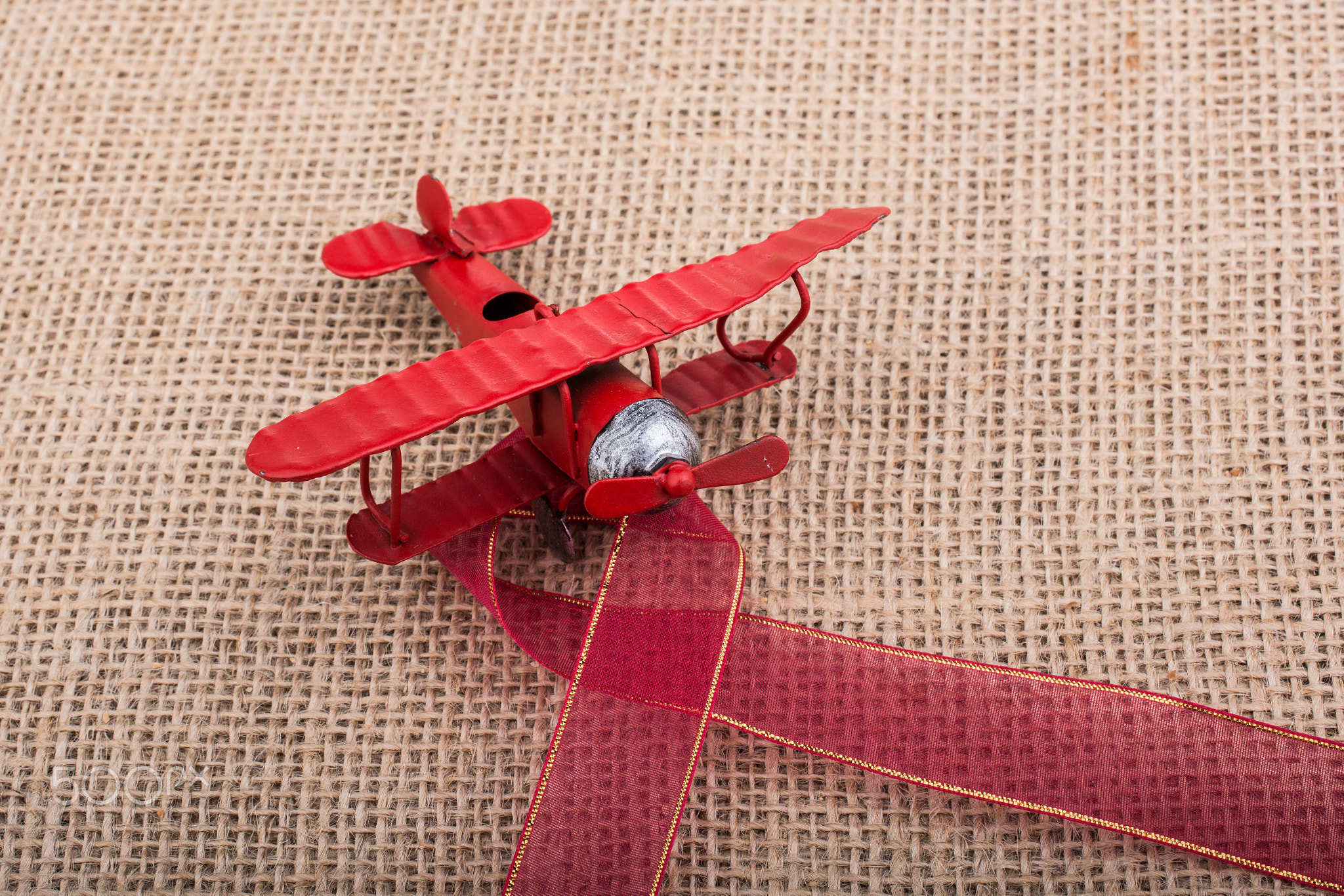 Toy airplane on linen canvas background