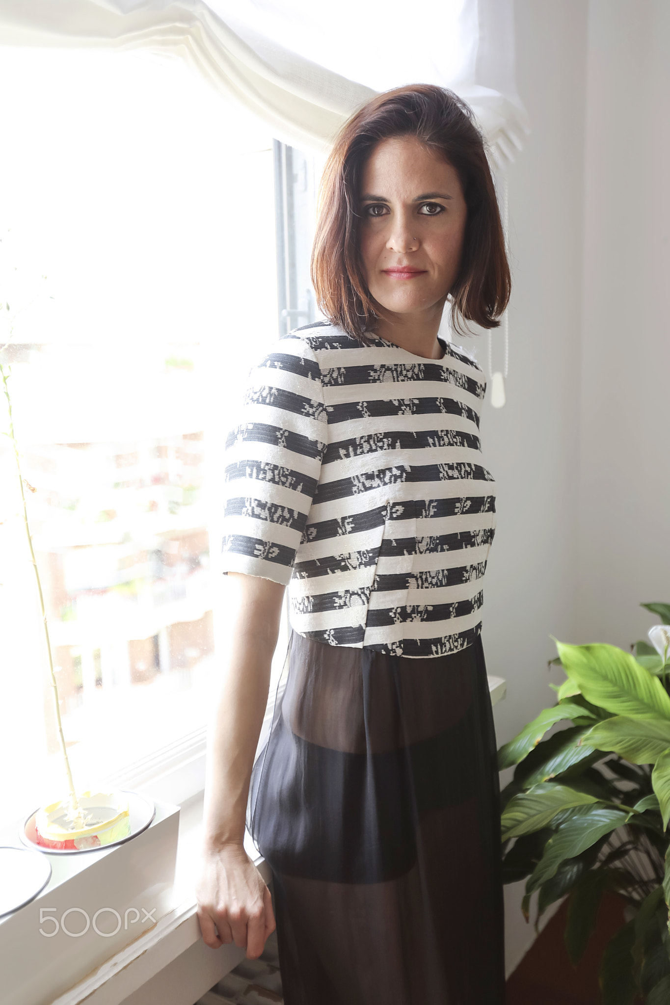 Fashion art portrait of beautiful woman at the window