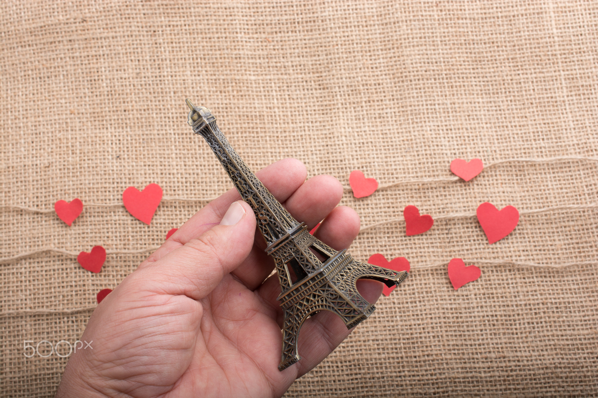 Love concept with Eiffel tower in hand and heart