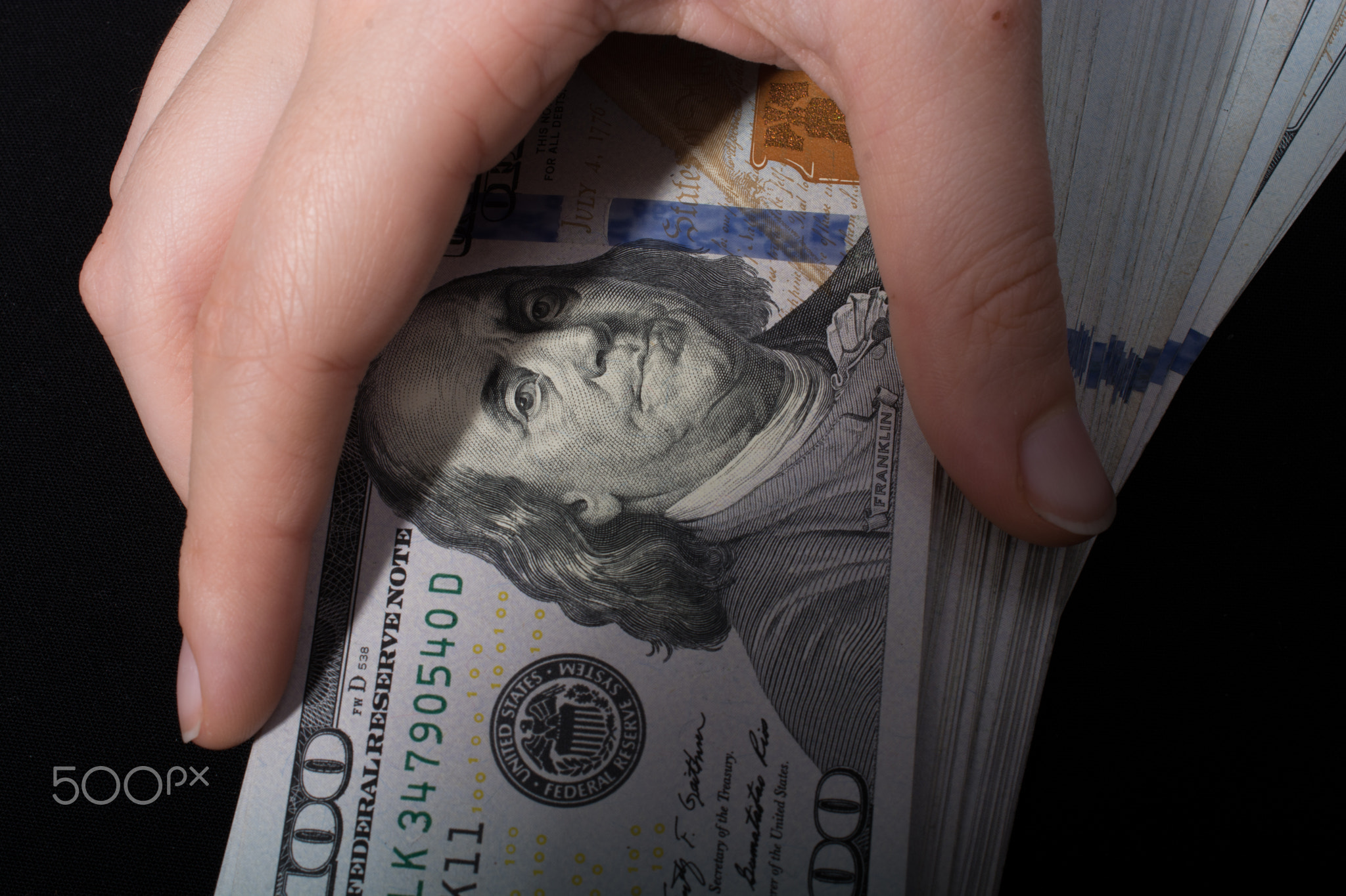 Hand holding American dollar isolated on white background