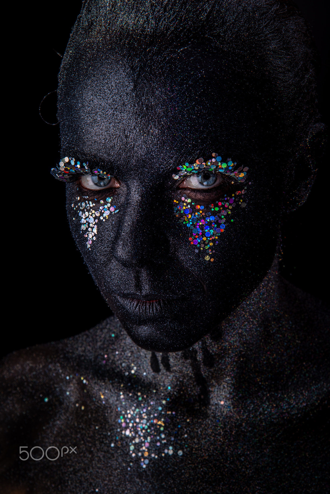 Girl in black makeup with sparkles